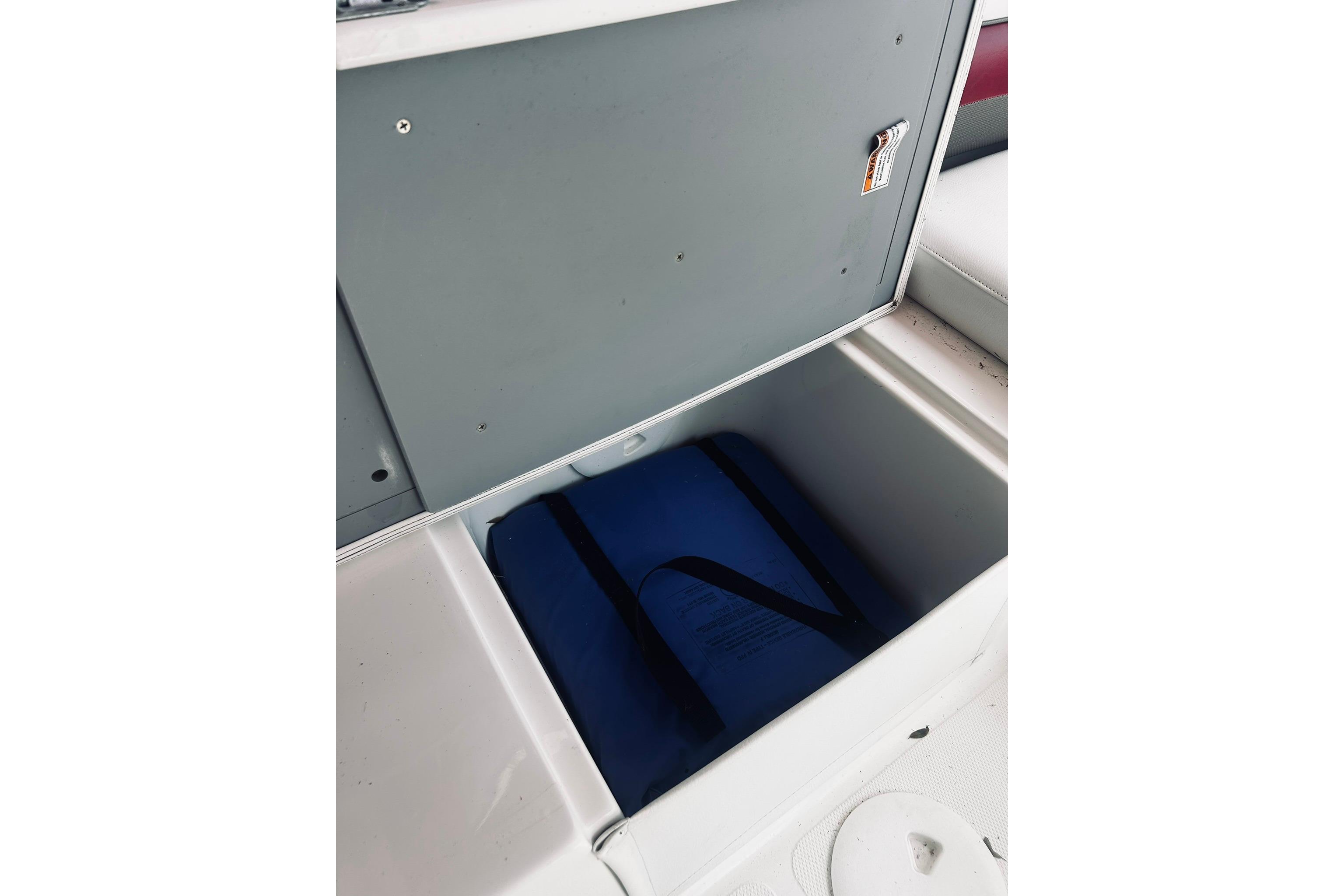 Open storage compartment on 2013 Hurricane SunDeck Sport 201 OB boat.