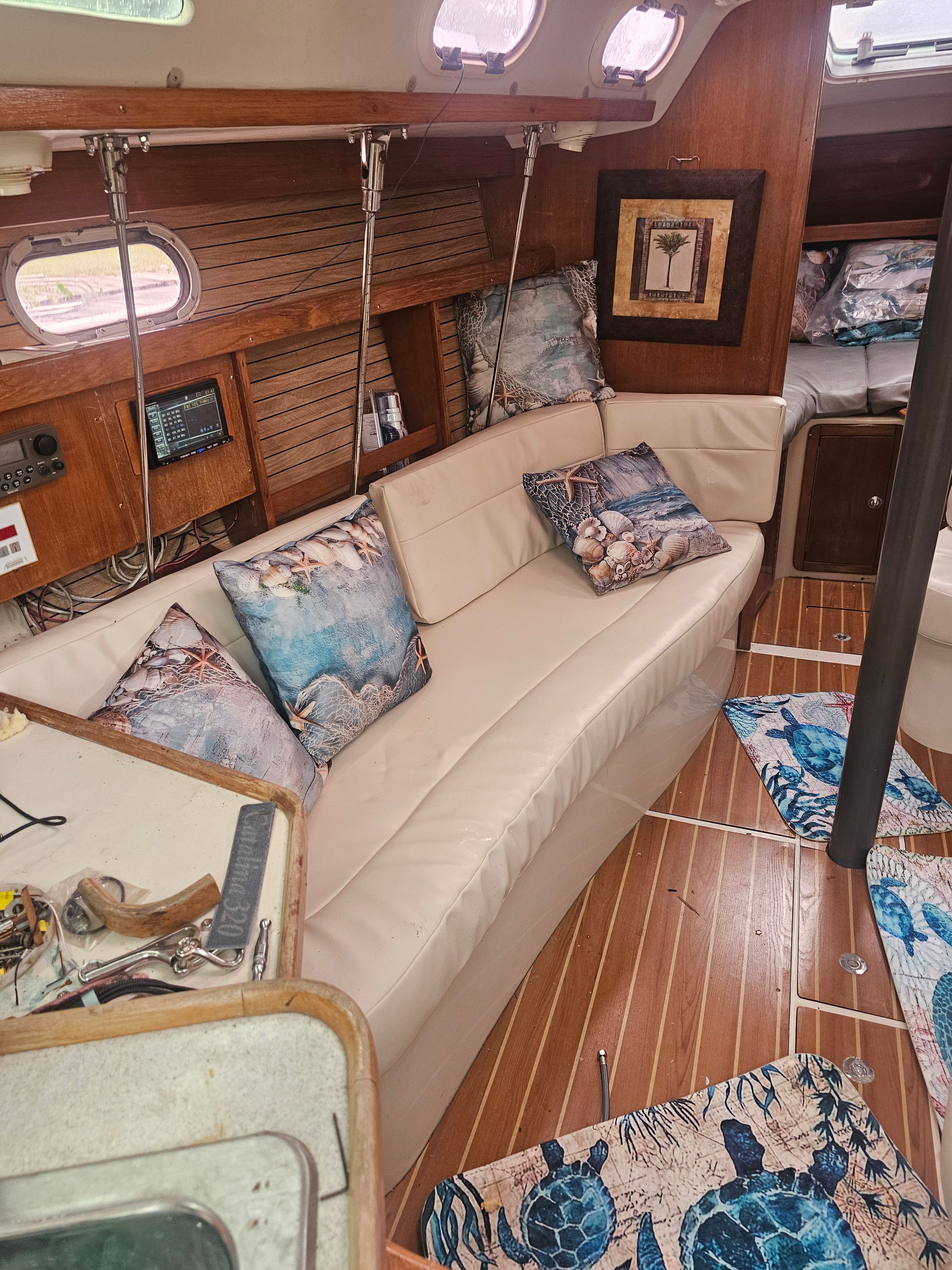Interior of a 2006 Catalina 320 yacht with cozy seating area.