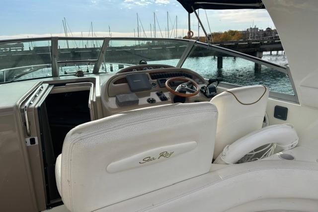 Cockpit of 2000 Sea Ray Sundancer 310 yacht with marina view.