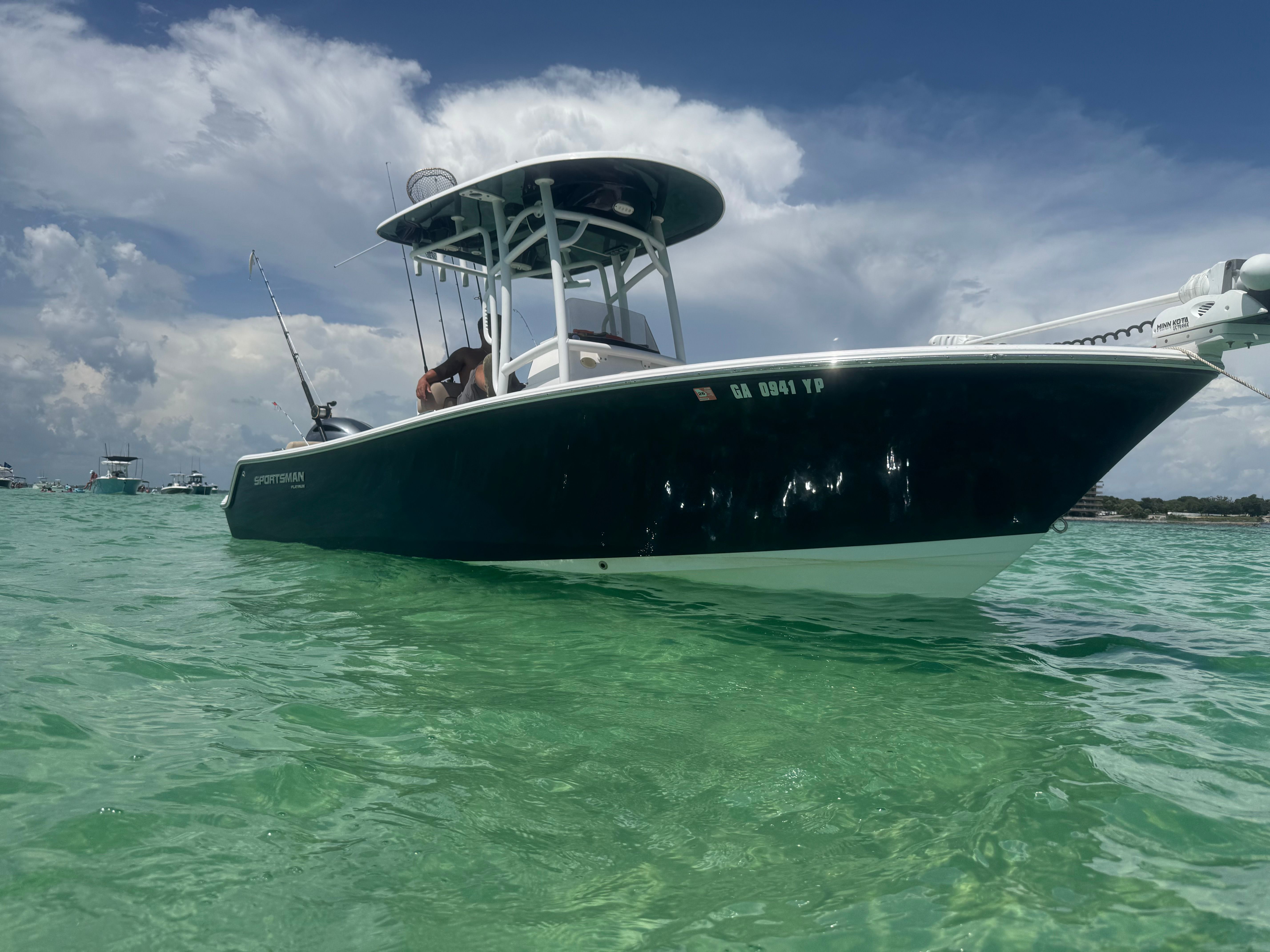 Sportsman Heritage 211 Center Console 2020 in clear water, with blue sky in the background.