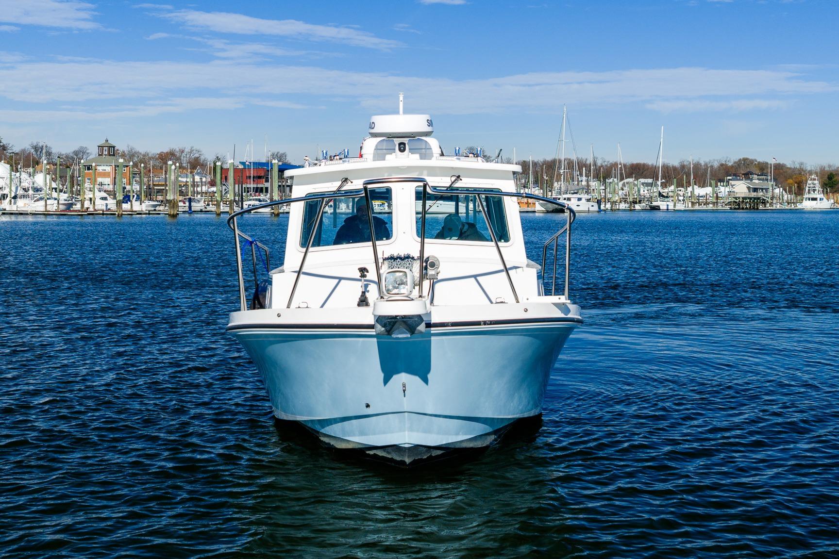 2024 Steiger Craft 31 Fisherman boat on calm water, marina background.