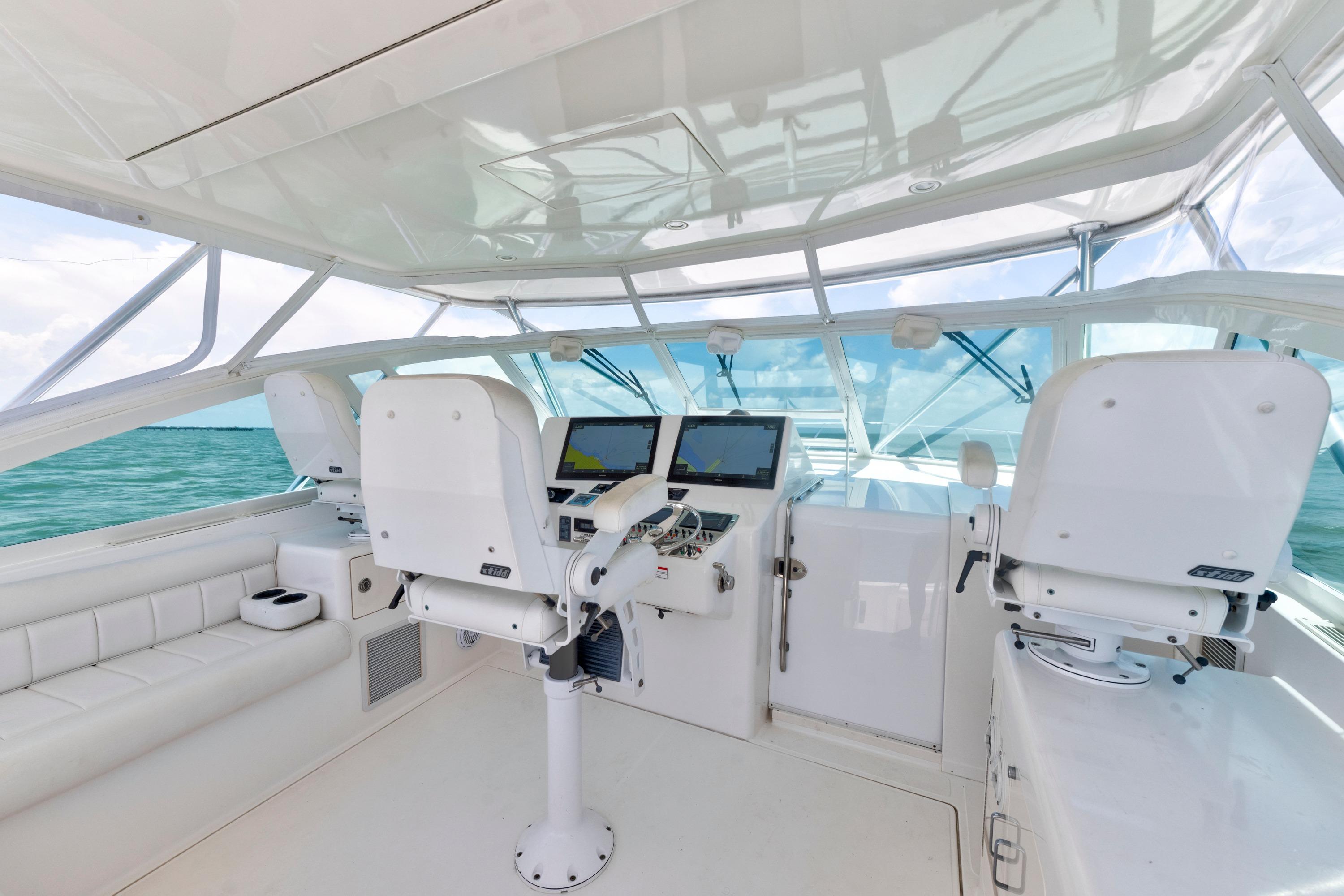 2010 Cabo 45 Express yacht helm with modern navigation equipment and ocean view.