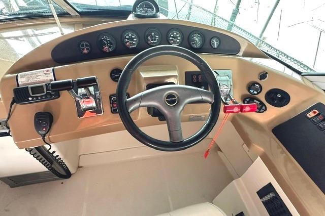 2004 Carver 360 Mariner helm with steering wheel and control panel.