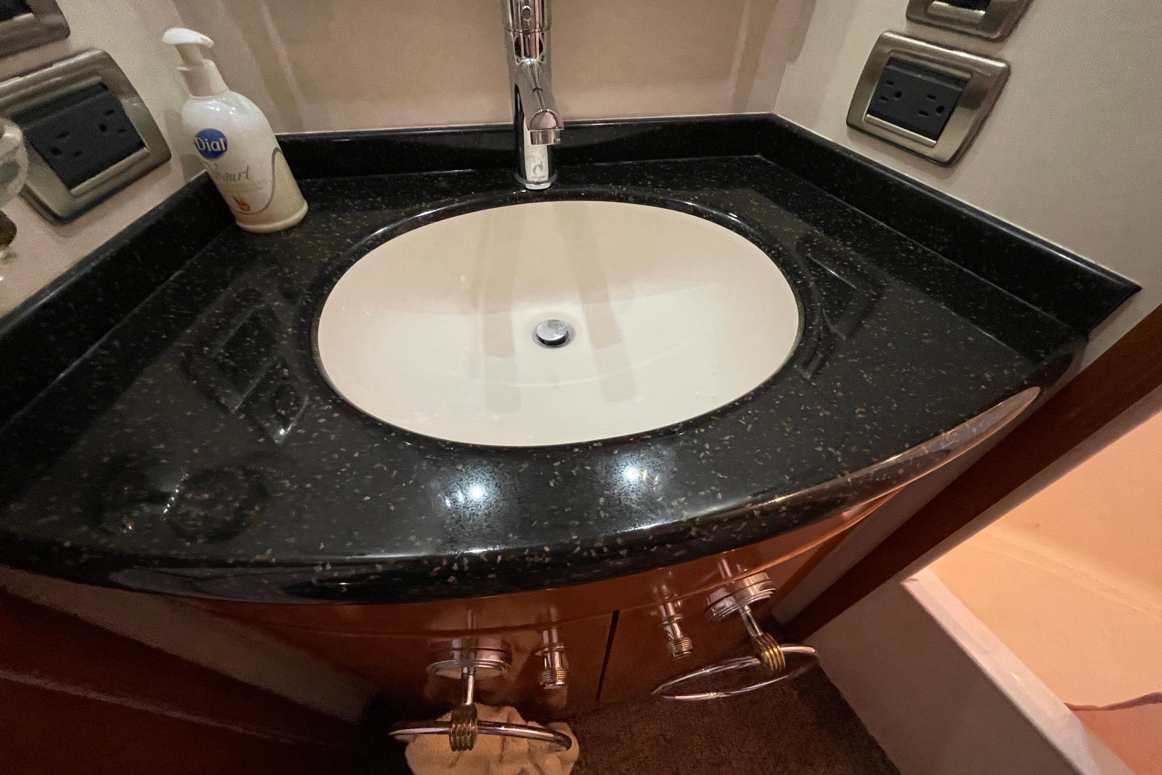 Bathroom sink with black countertop in 2002 Carver 570 Voyager Pilothouse yacht.