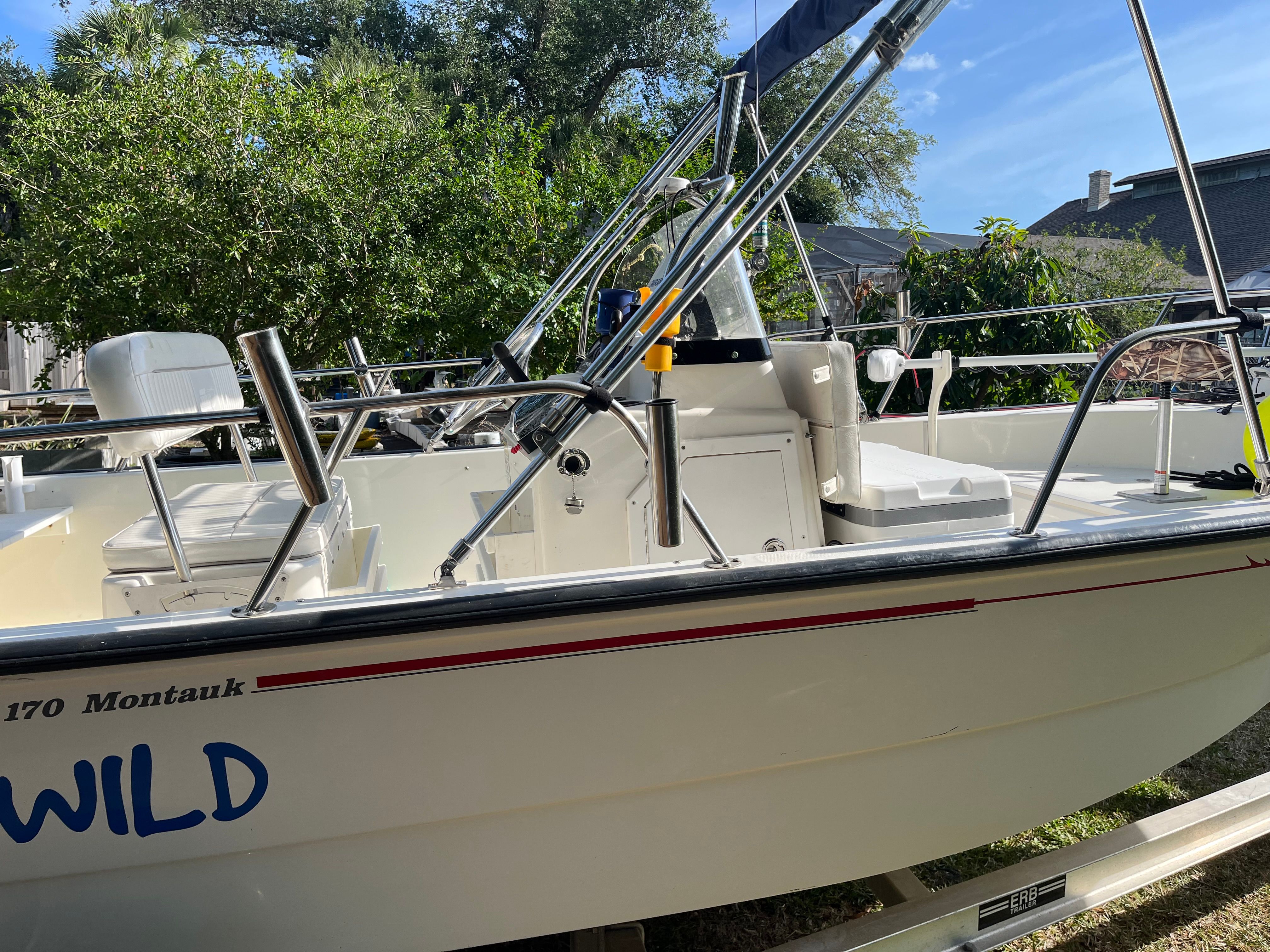 Boston Whaler 170 Montauk 2005 on trailer in garden.