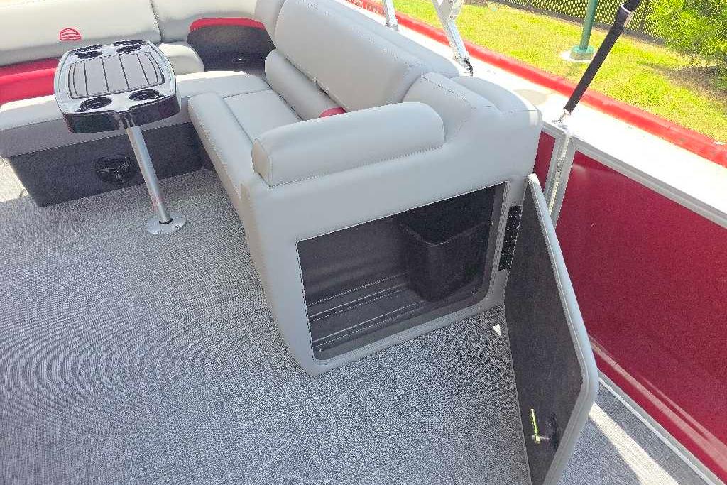 Interior of 2026 Sun Tracker Party Barge 20 DLX with seating and storage compartment.