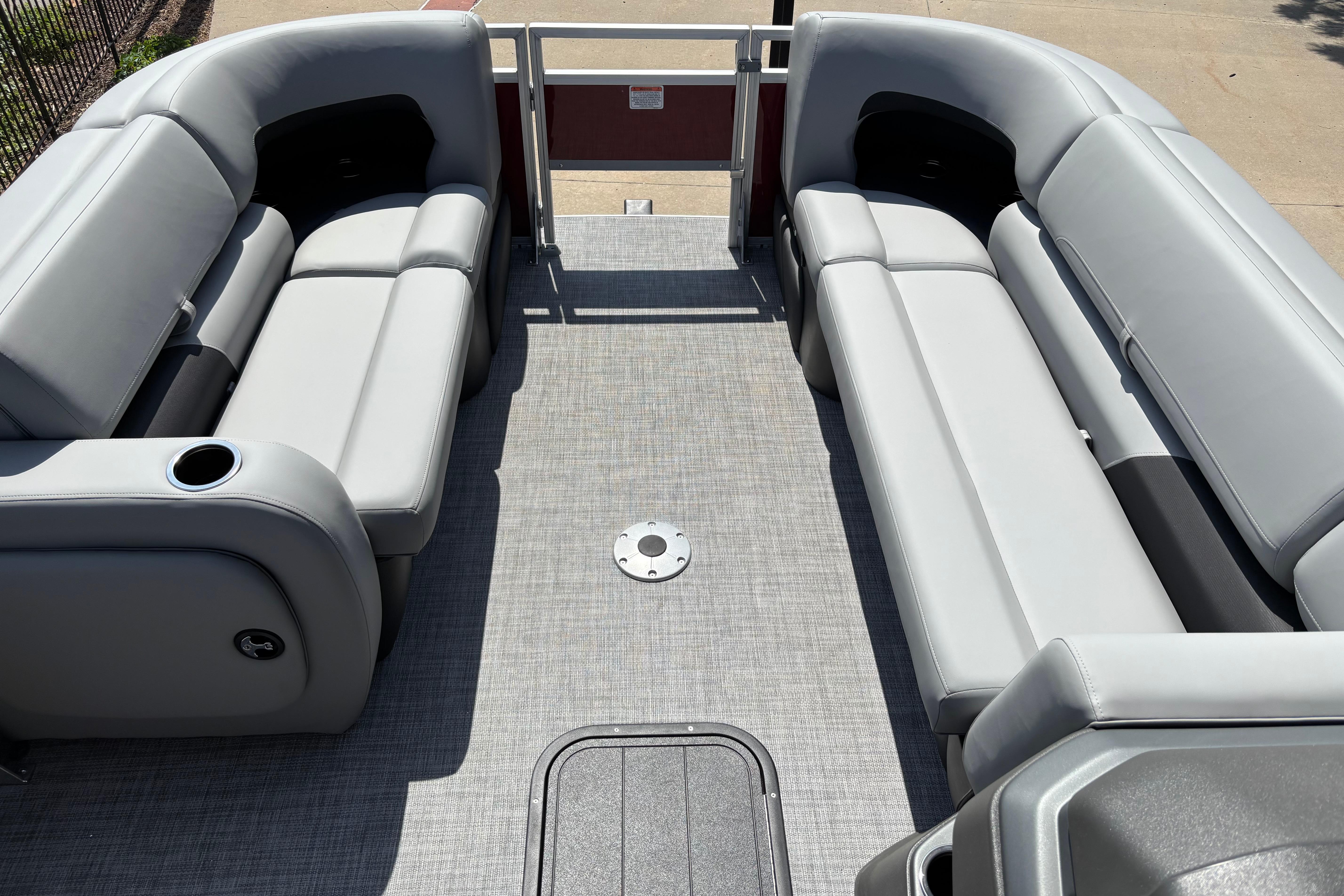 2026 Sun Tracker SportFish 22 XP3 pontoon boat interior with gray seating and flooring.