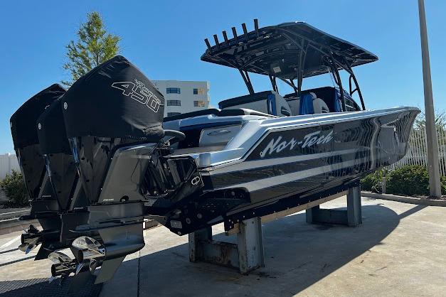 2022 Nor-Tech 390 Sport Center Console boat with dual engines on display.