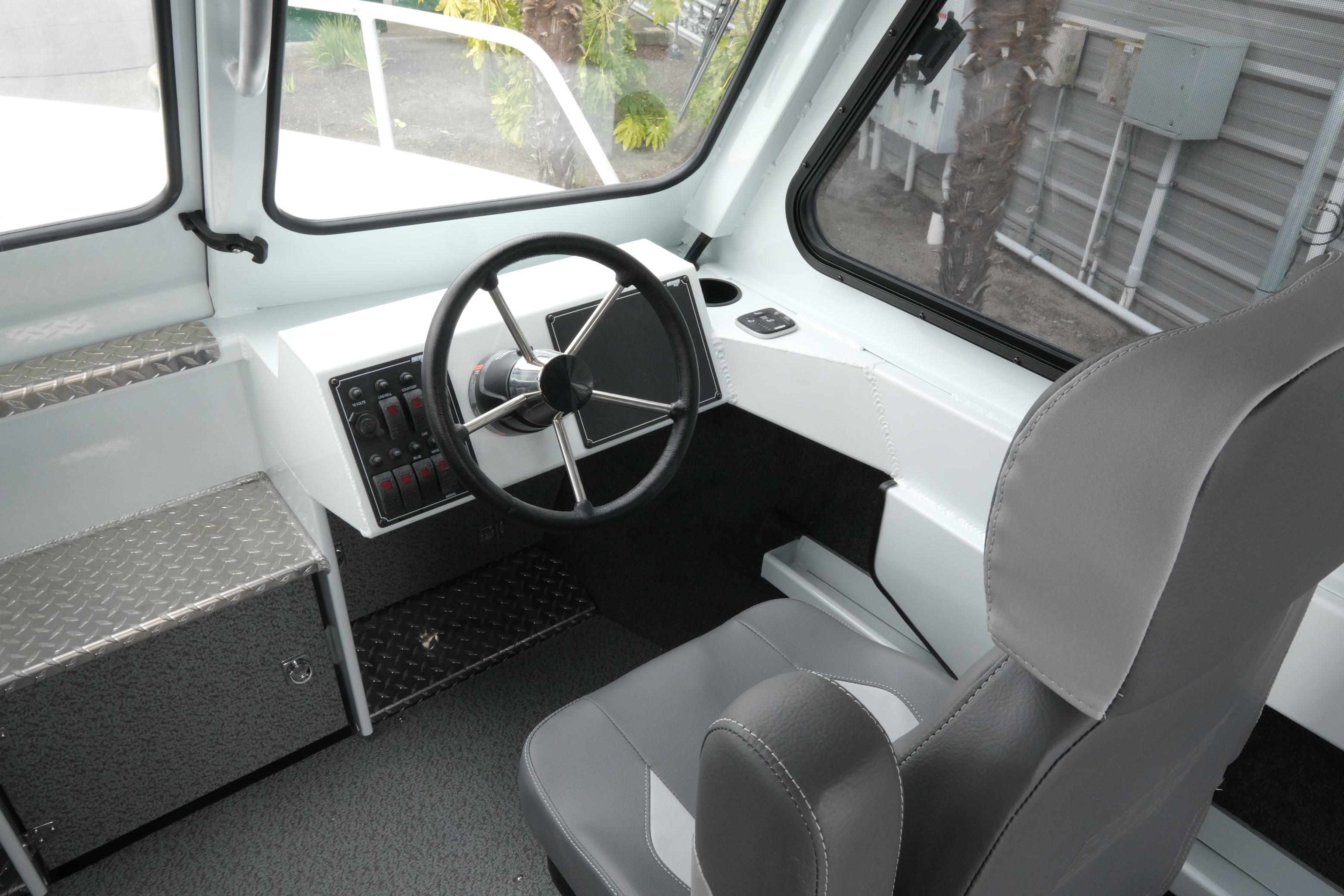 Interior of 2026 Hewescraft 210 Sea Runner ET Hardtop, featuring steering wheel and controls.