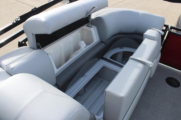 2025 Regency 230 DL3 boat interior with open storage compartments and cushioned seating.
