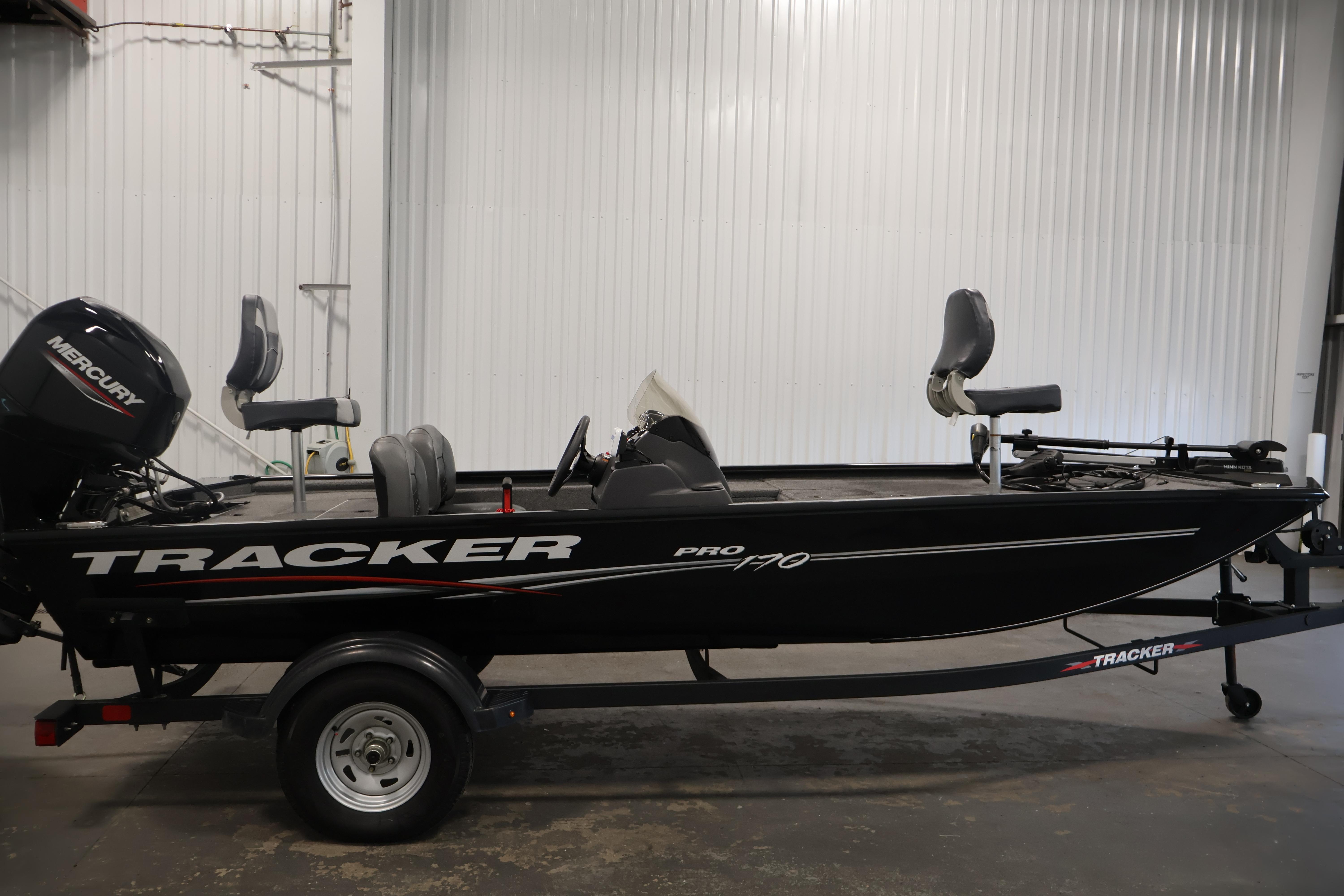 2024 Tracker Pro 170 fishing boat with Mercury engine in a garage setting.
