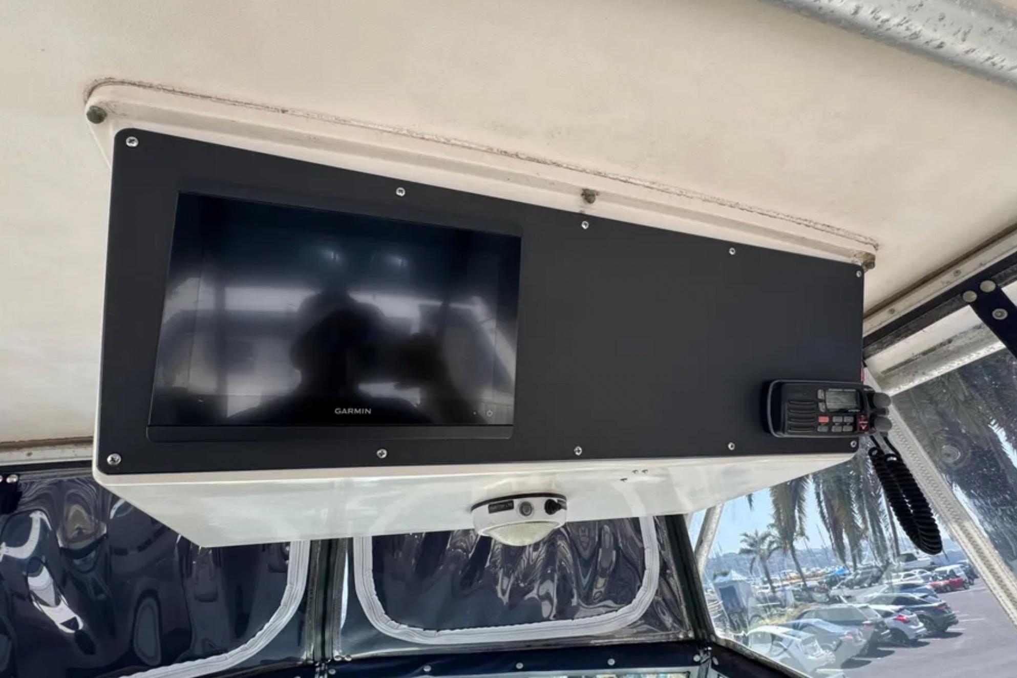 Garmin display and radio on 1990 Grady-White Marlin 280 boat dashboard.