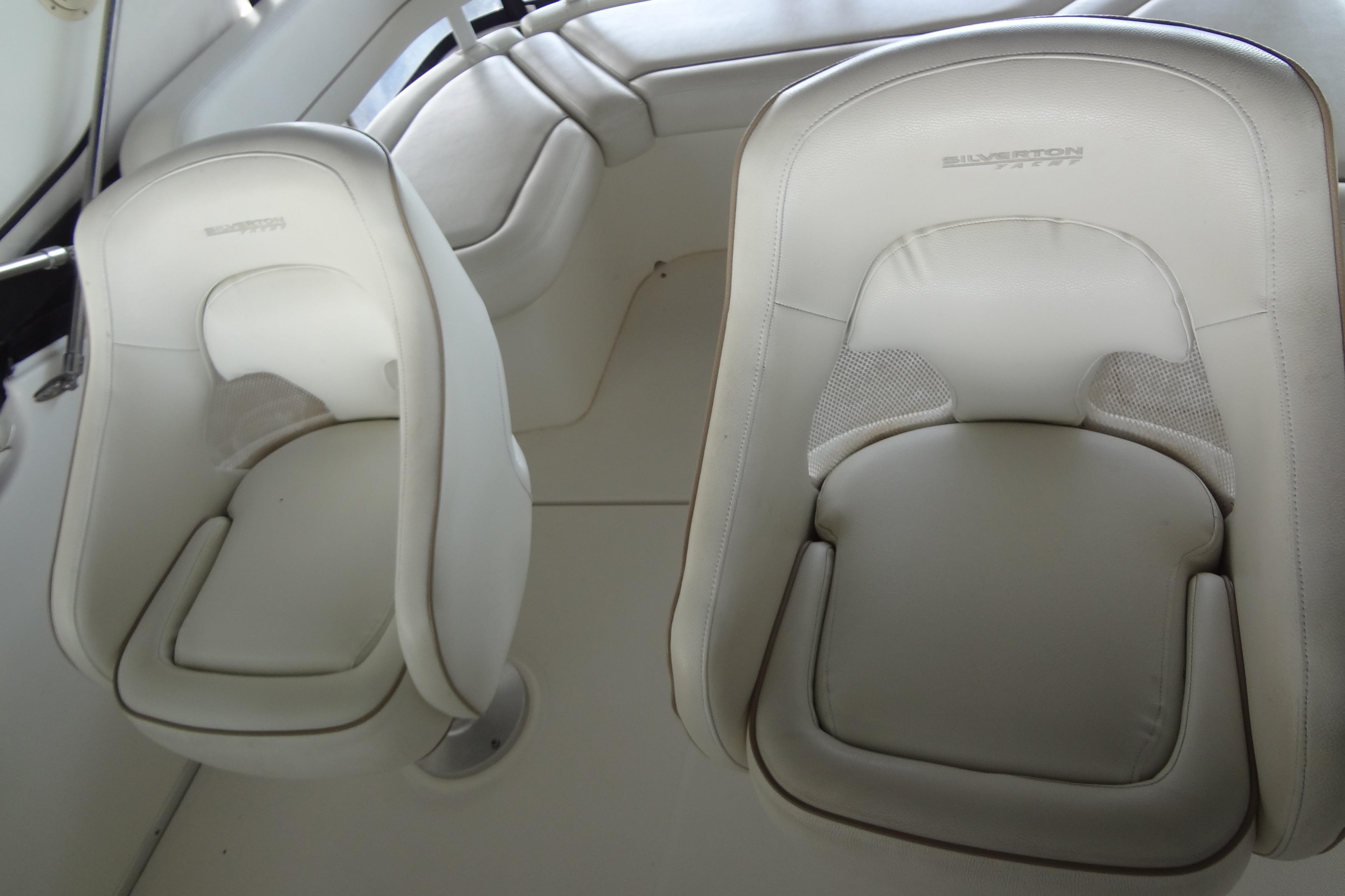 2005 Silverton 34 Convertible boat interior with white cushioned seats.
