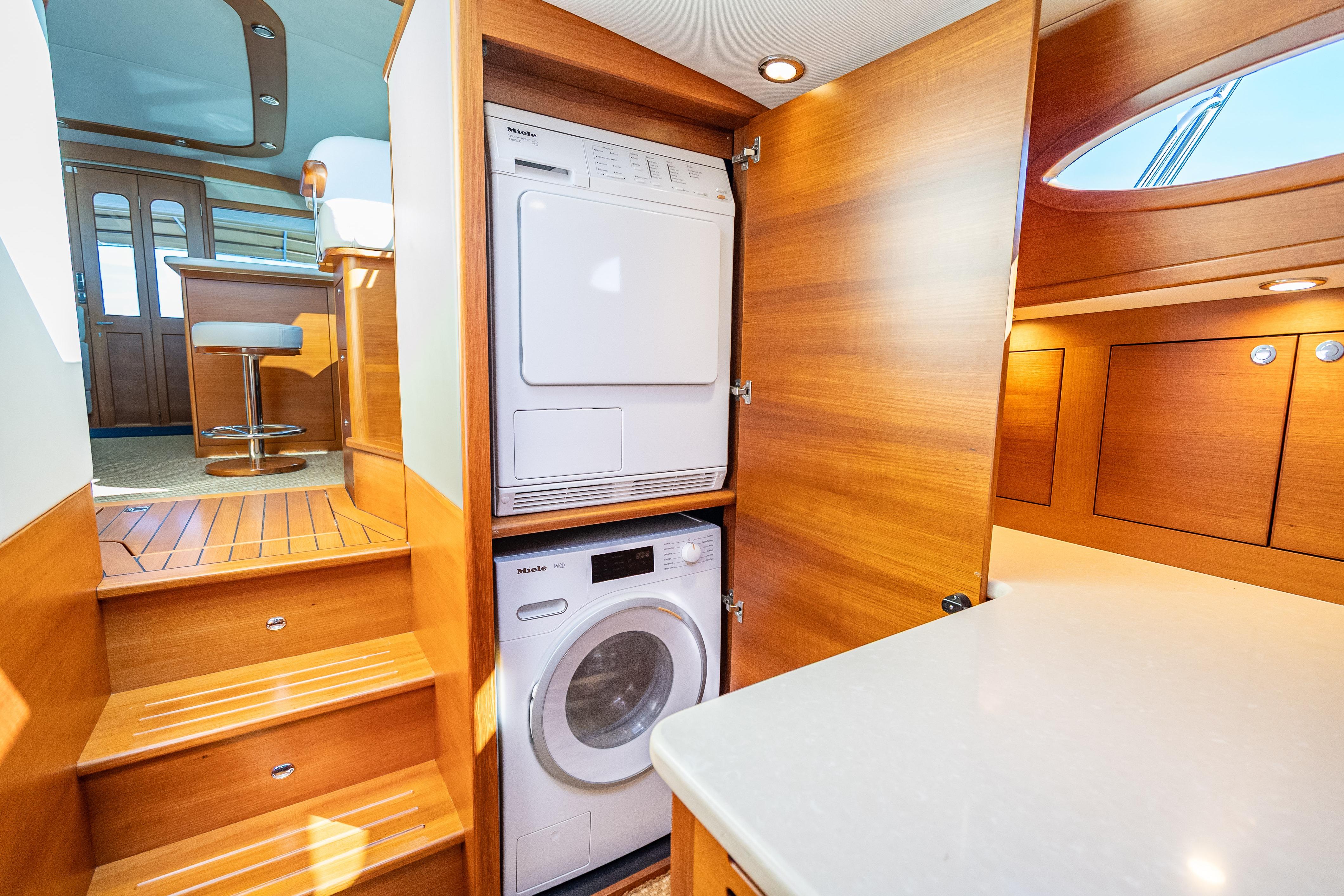 Laundry area inside 2018 Palm Beach Motor Yachts PB55, featuring Miele washer and dryer.