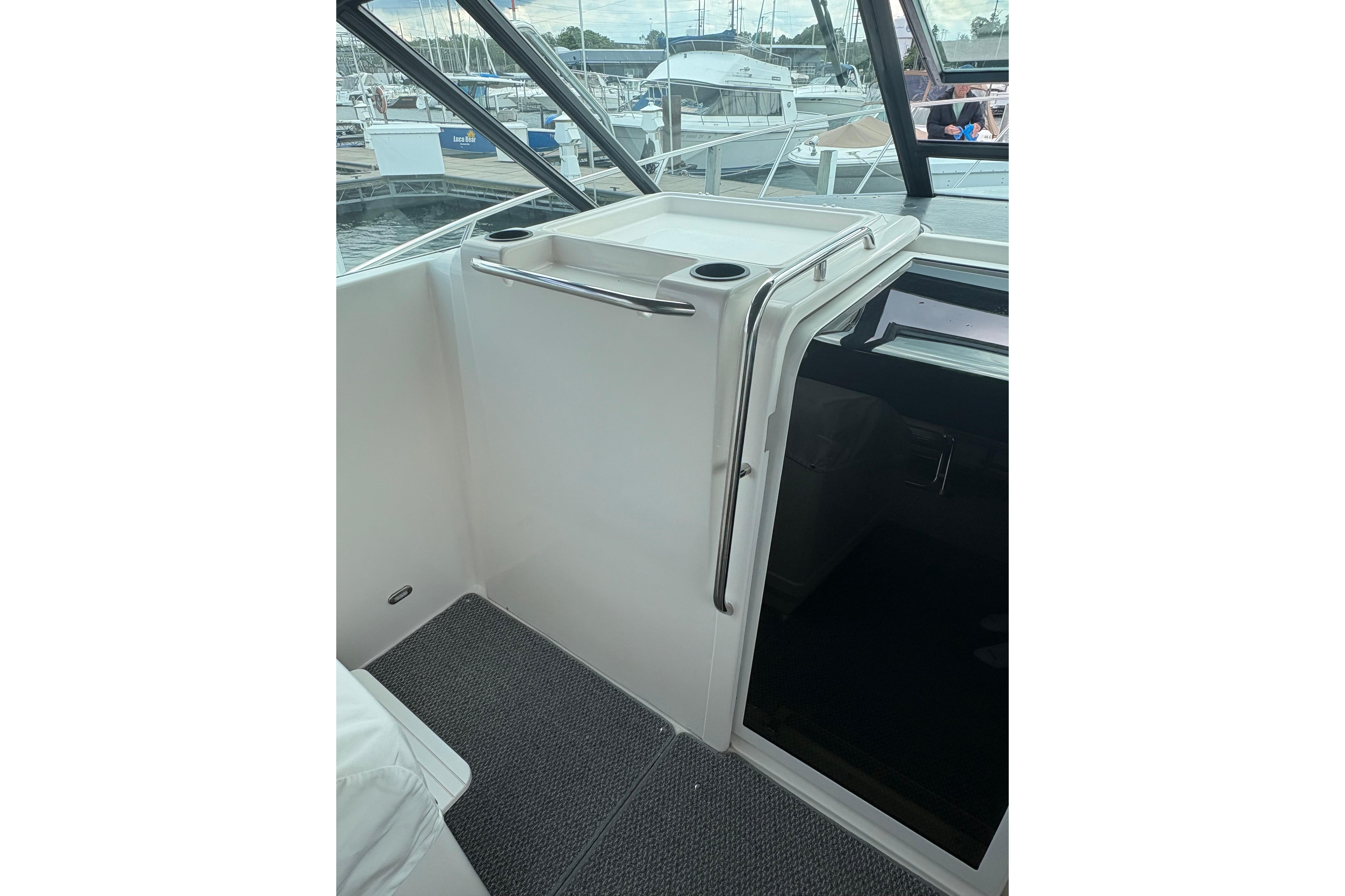 1999 Tiara Yachts 3100 Open interior with cockpit view and marina background.