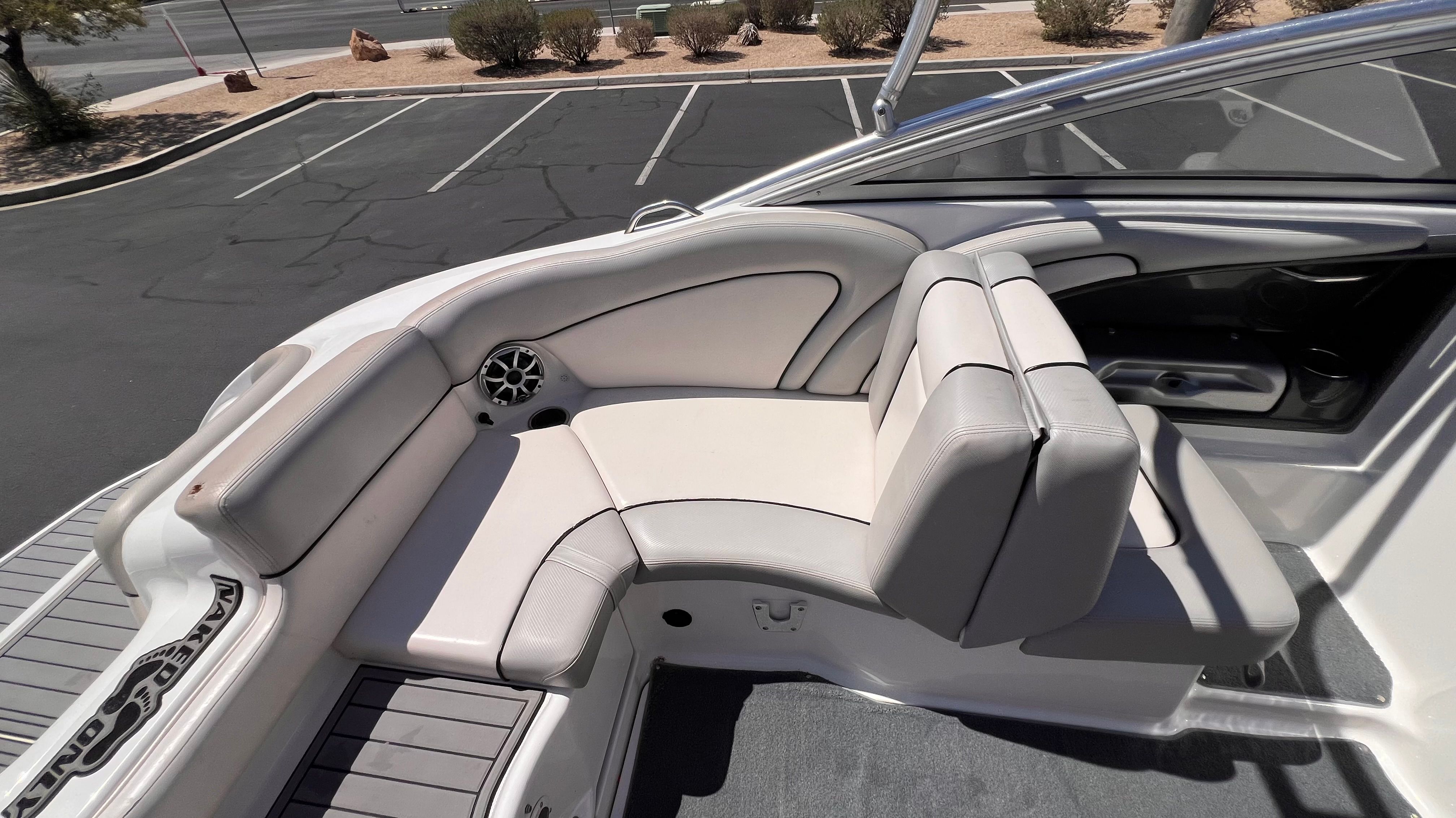 Yamaha AR240 HO 2011 boat seating area in a parking lot.