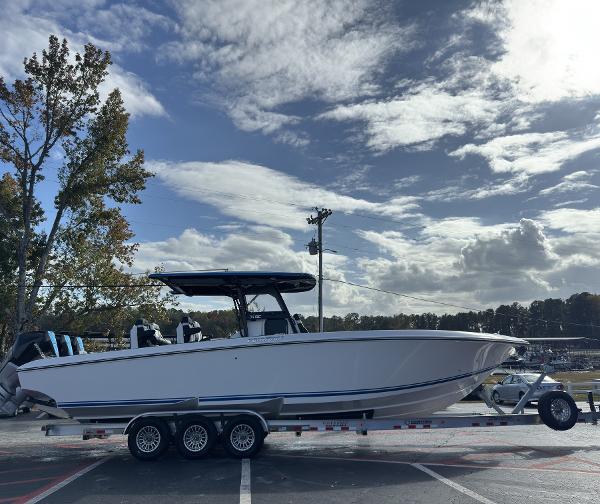2024 Fountain 34 SC boat on trailer under cloudy sky.