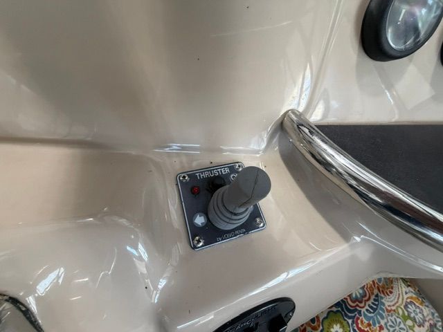 Close-up of a control lever on a yacht, surrounded by a cream-colored dashboard.