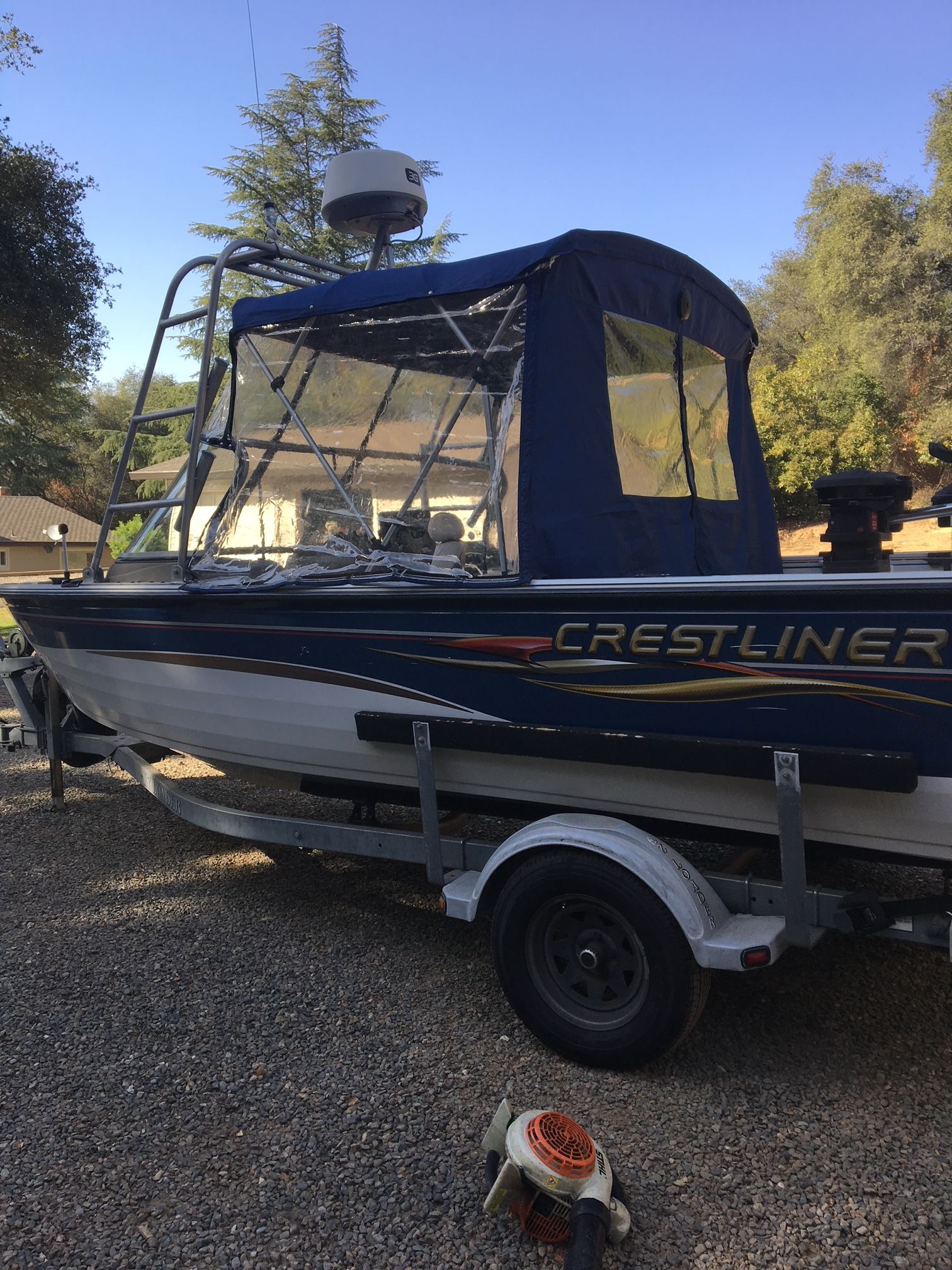 2007 Crestliner Mirage 2000 boat parked on trailer outdoors.