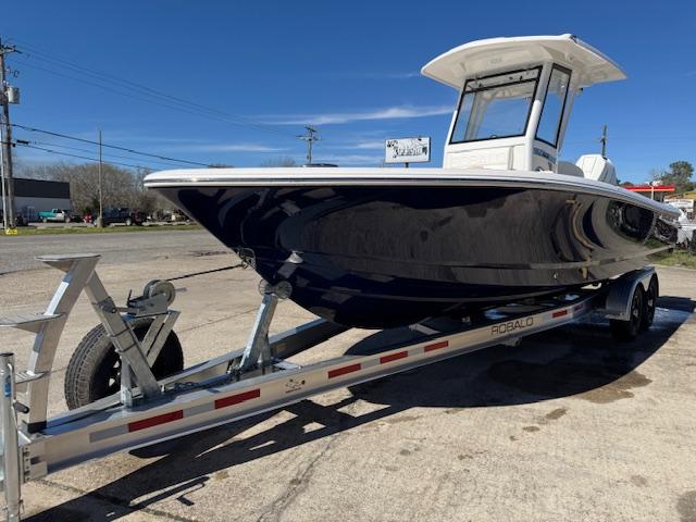 2025 Robalo 266 Cayman boat on trailer, parked outdoors under clear blue sky.