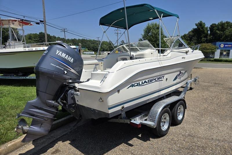 2004 Aquasport 215 Osprey Sport boat with Yamaha outboard motor on trailer.
