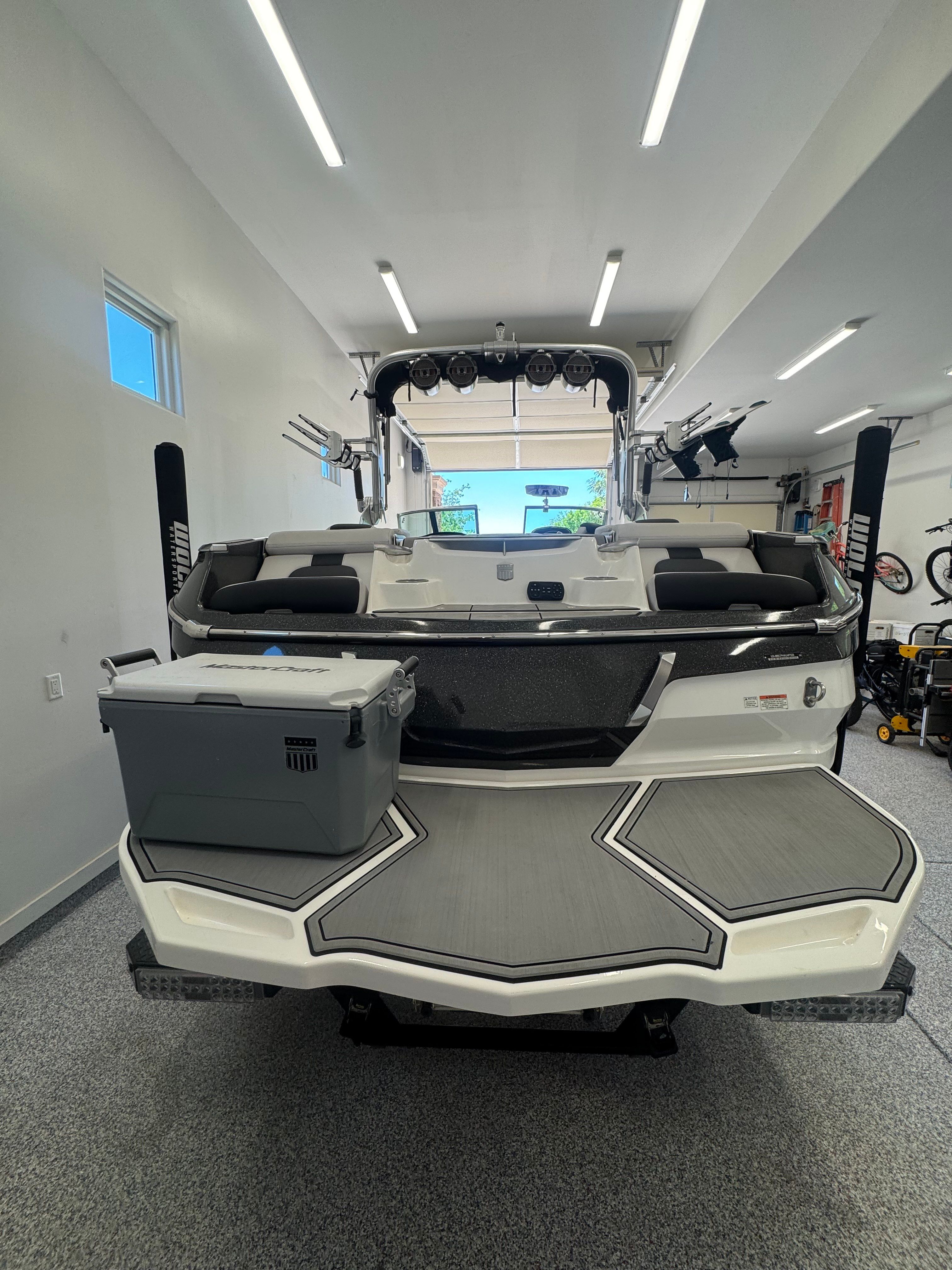 2020 MasterCraft X24 boat parked in a garage.