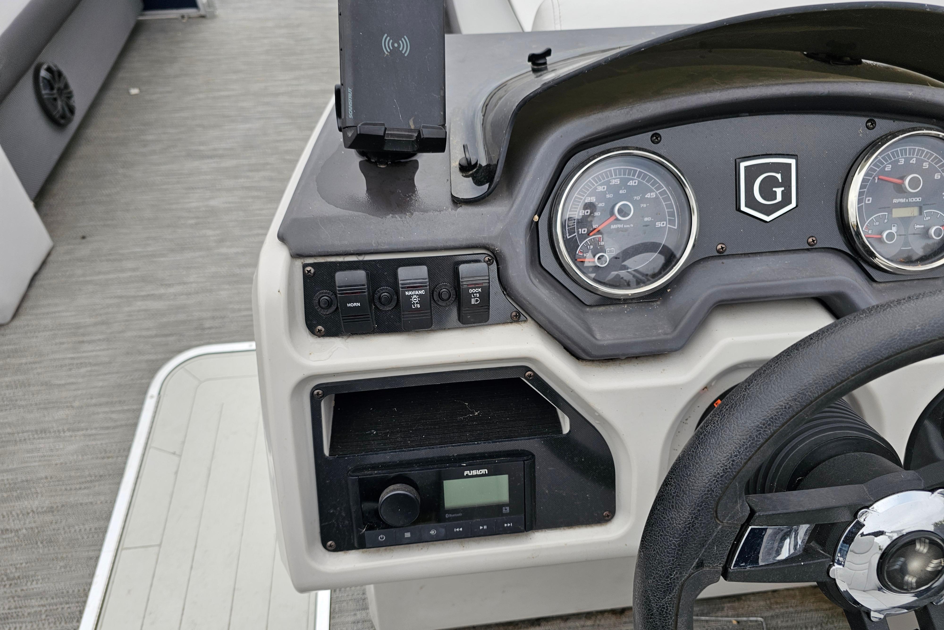 2022 Sweetwater 2286 SFL boat dashboard with gauges and controls.