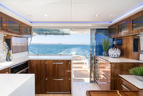 Luxurious interior of 2021 Riviera 5400 Sport Yacht with ocean view.