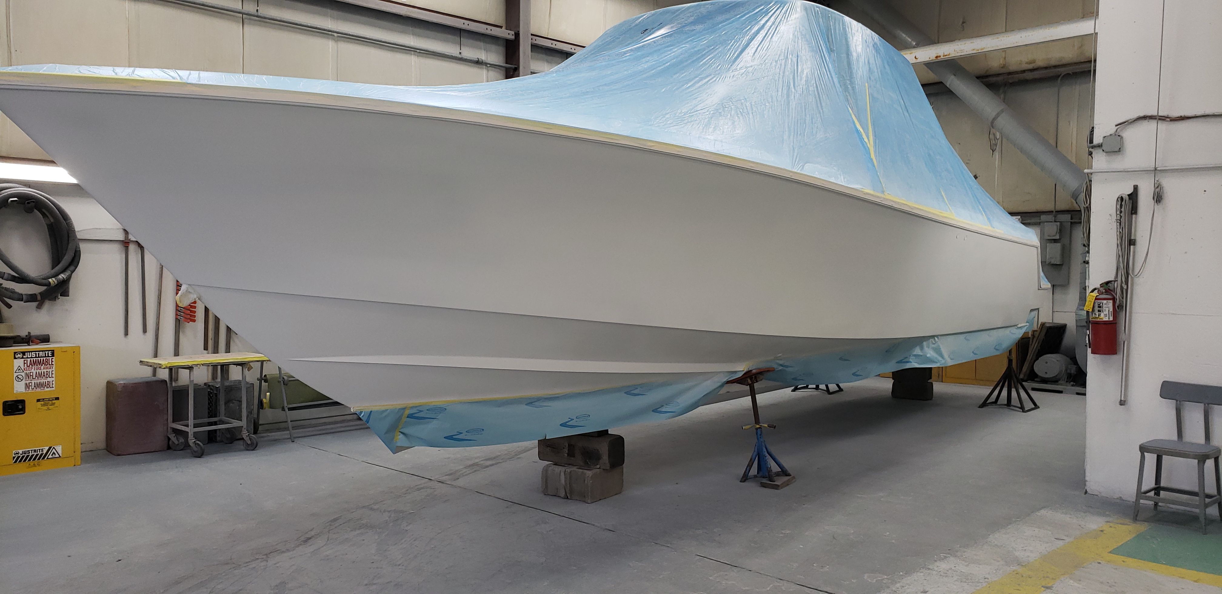 2009 Contender 33 Tournament boat under workshop cover.