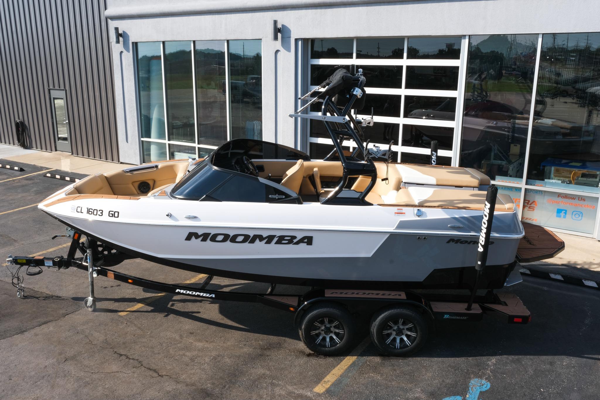 2023 Moomba Mondo boat on trailer outside dealership, showcasing sleek design and modern features.