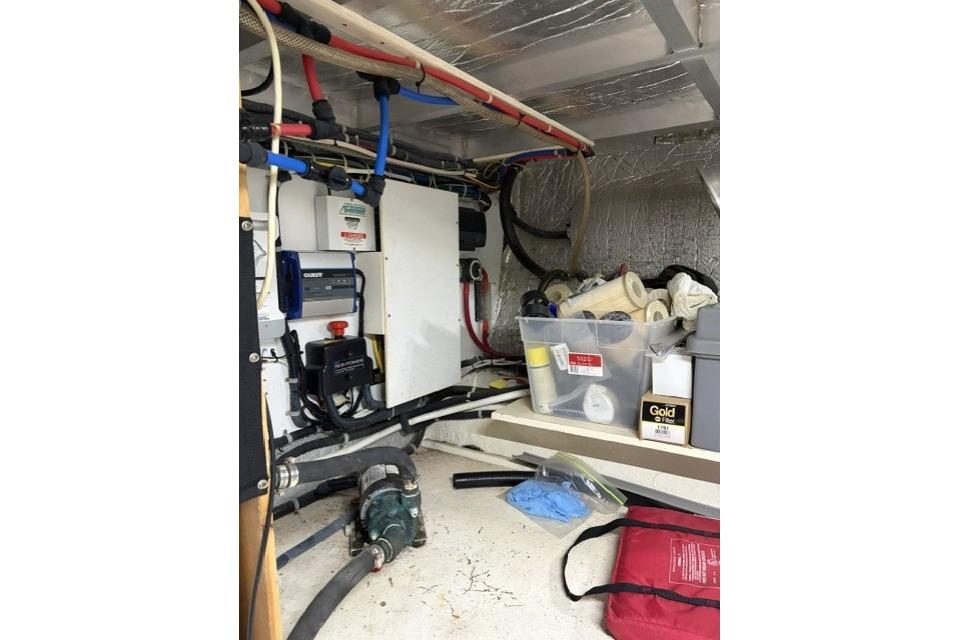 Engine room of a 2007 Navigator 5100 yacht with various equipment and supplies.