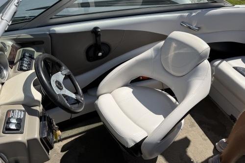 2012 Crownline 215 SS boat interior with steering wheel and white seating.