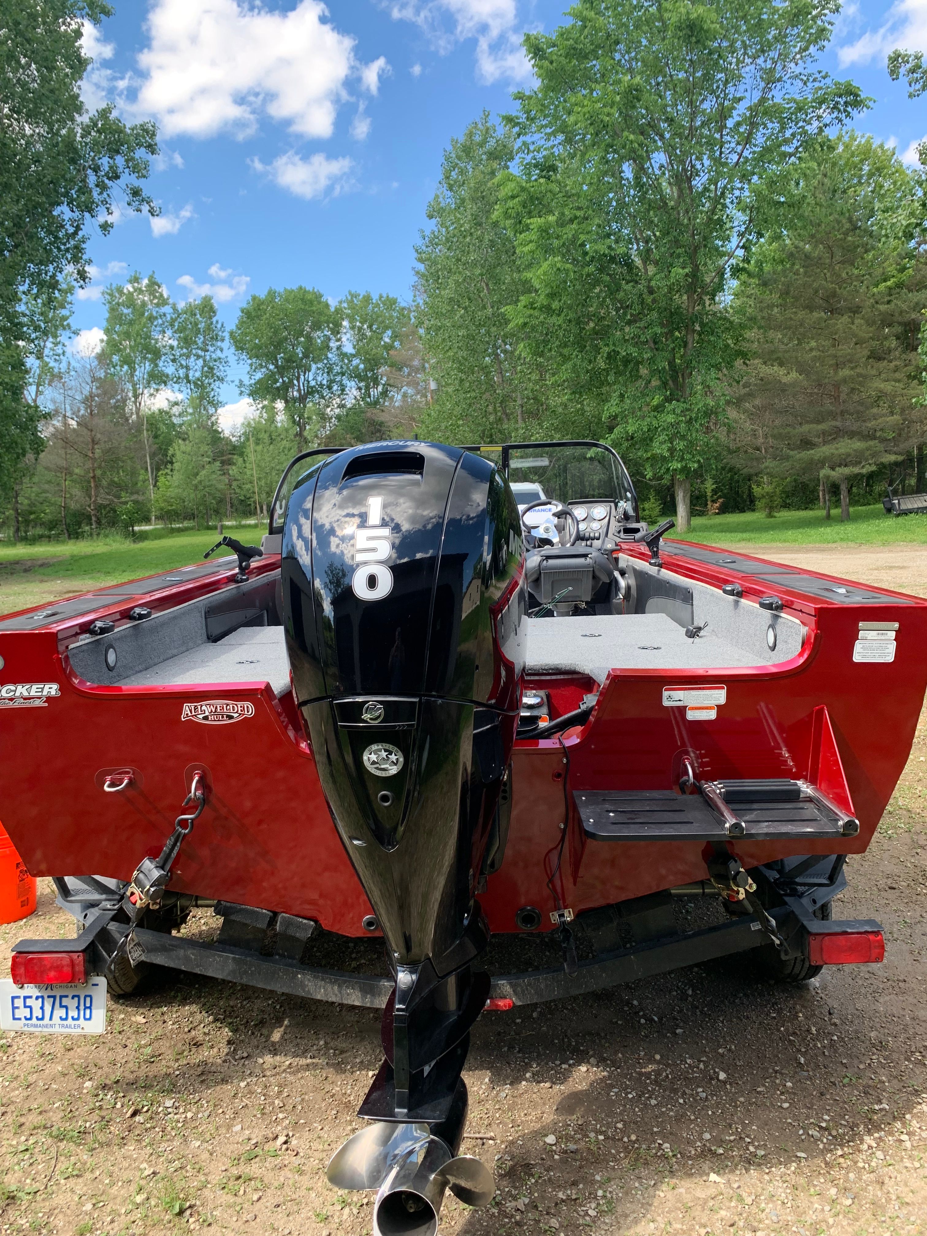 Red 2022 Tracker Targa V-19 WT with outboard motor.