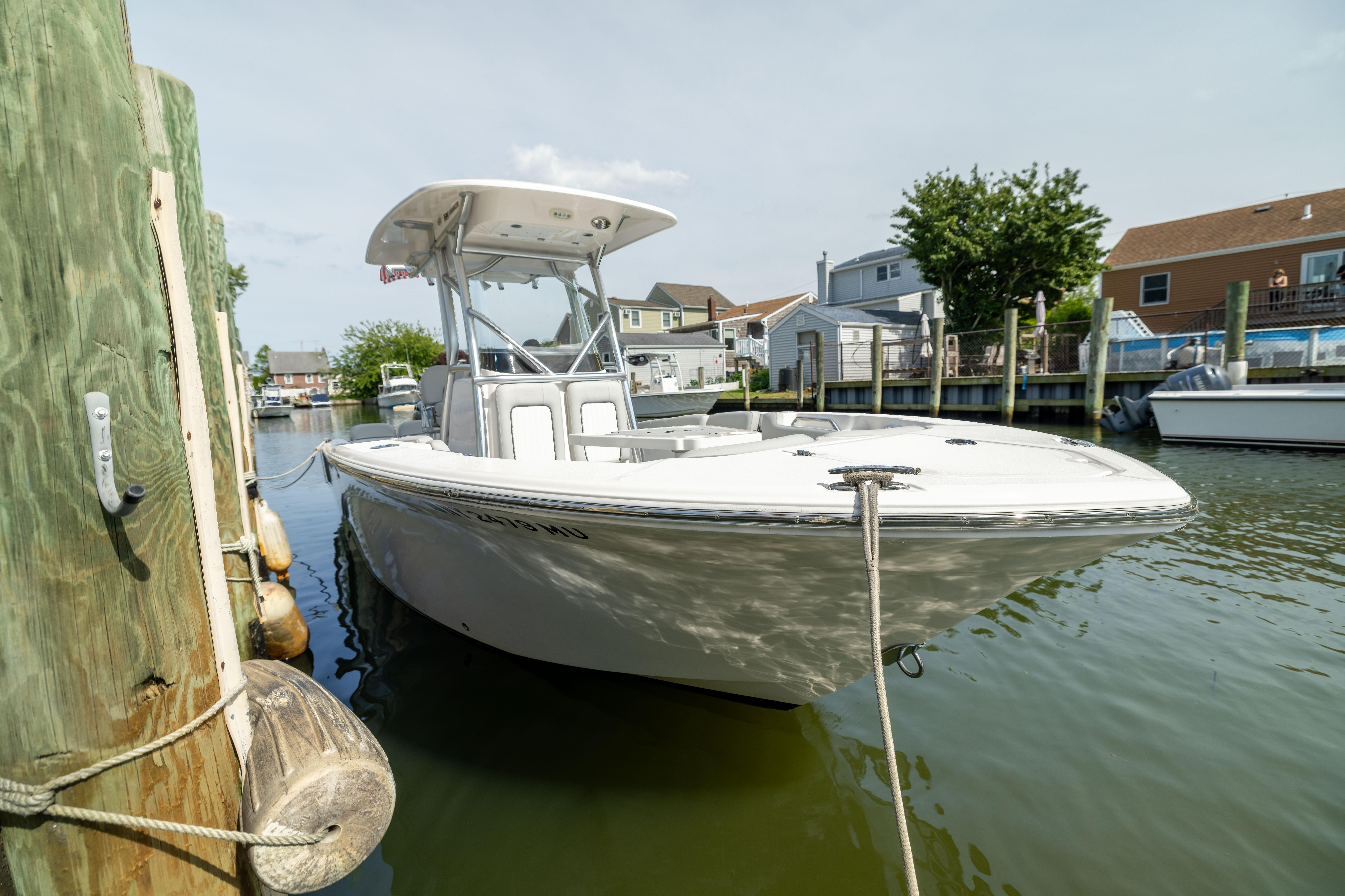 2023 Sea Fox 228 Commander boat docked in a serene marina setting.