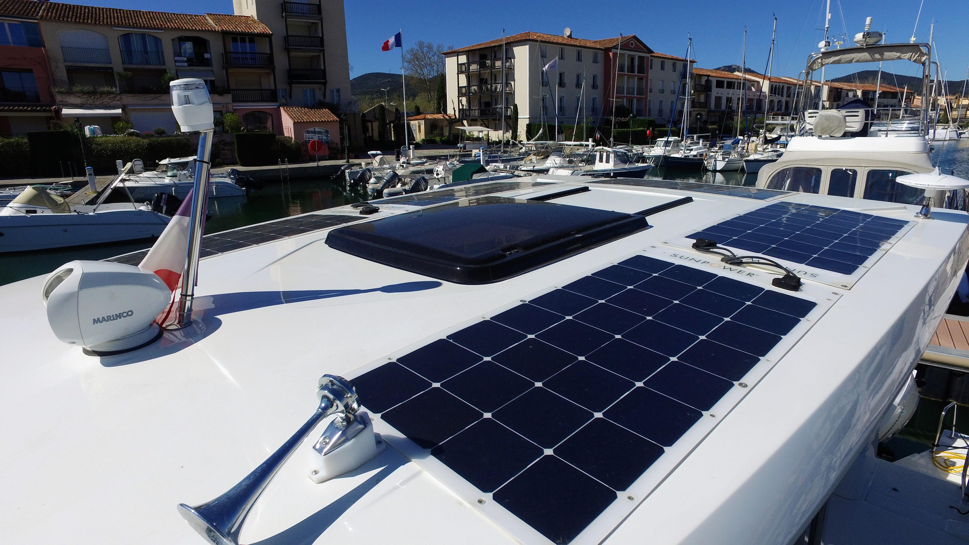 2023 Jeanneau CAP CAMARAT 12.5 WA with solar panels docked in a marina.