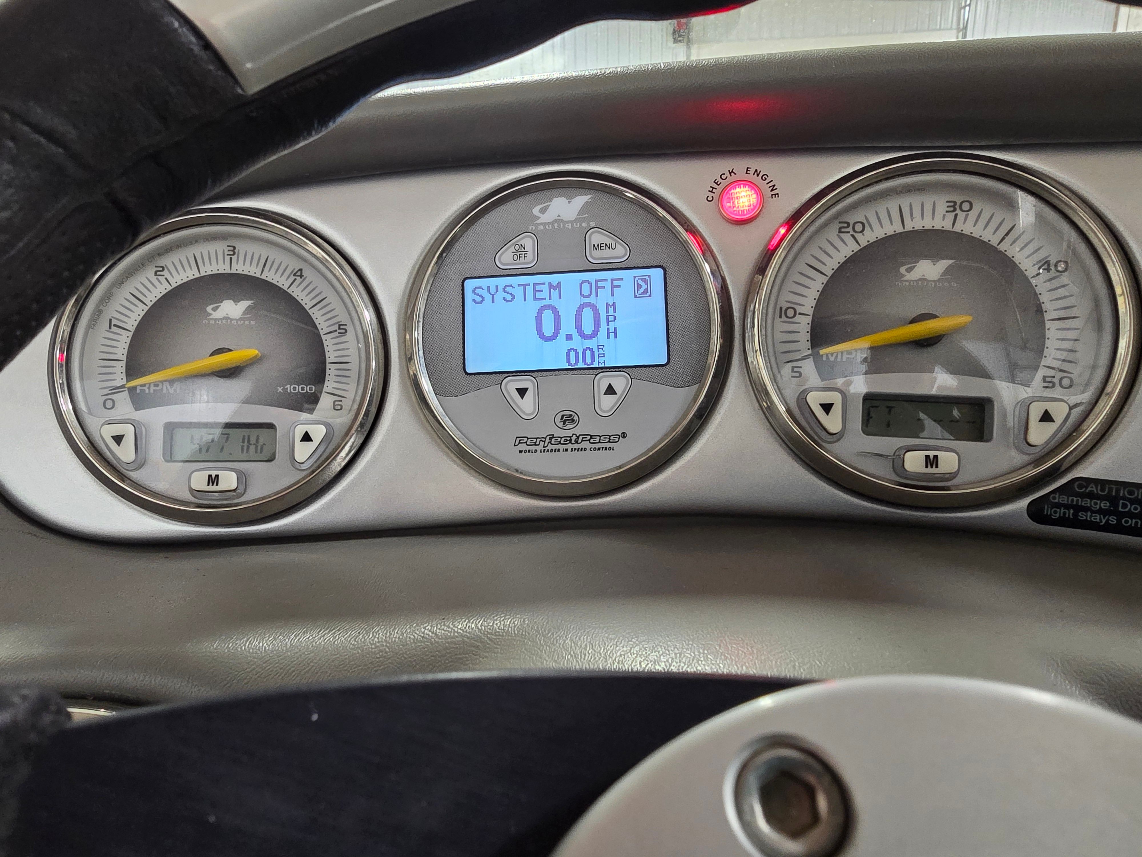 Dashboard of a 2006 Correct Craft 228 boat with digital gauges.