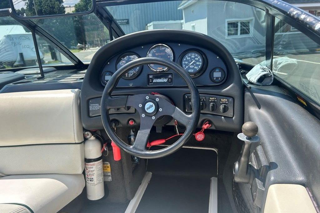 1999 Malibu Response boat dashboard with steering wheel and instrument panel.