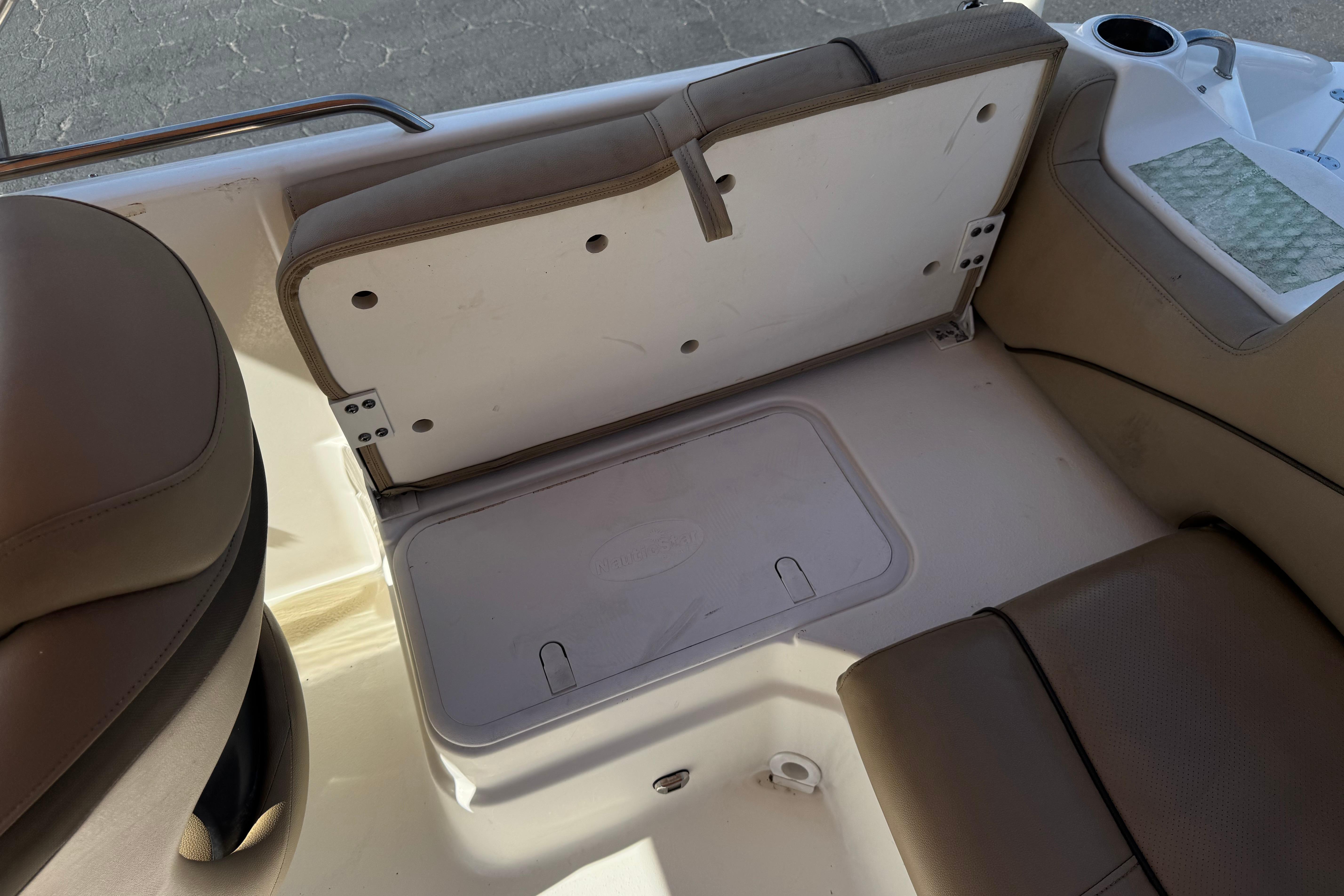 2020 NauticStar 203 SC boat interior seating with storage compartment.