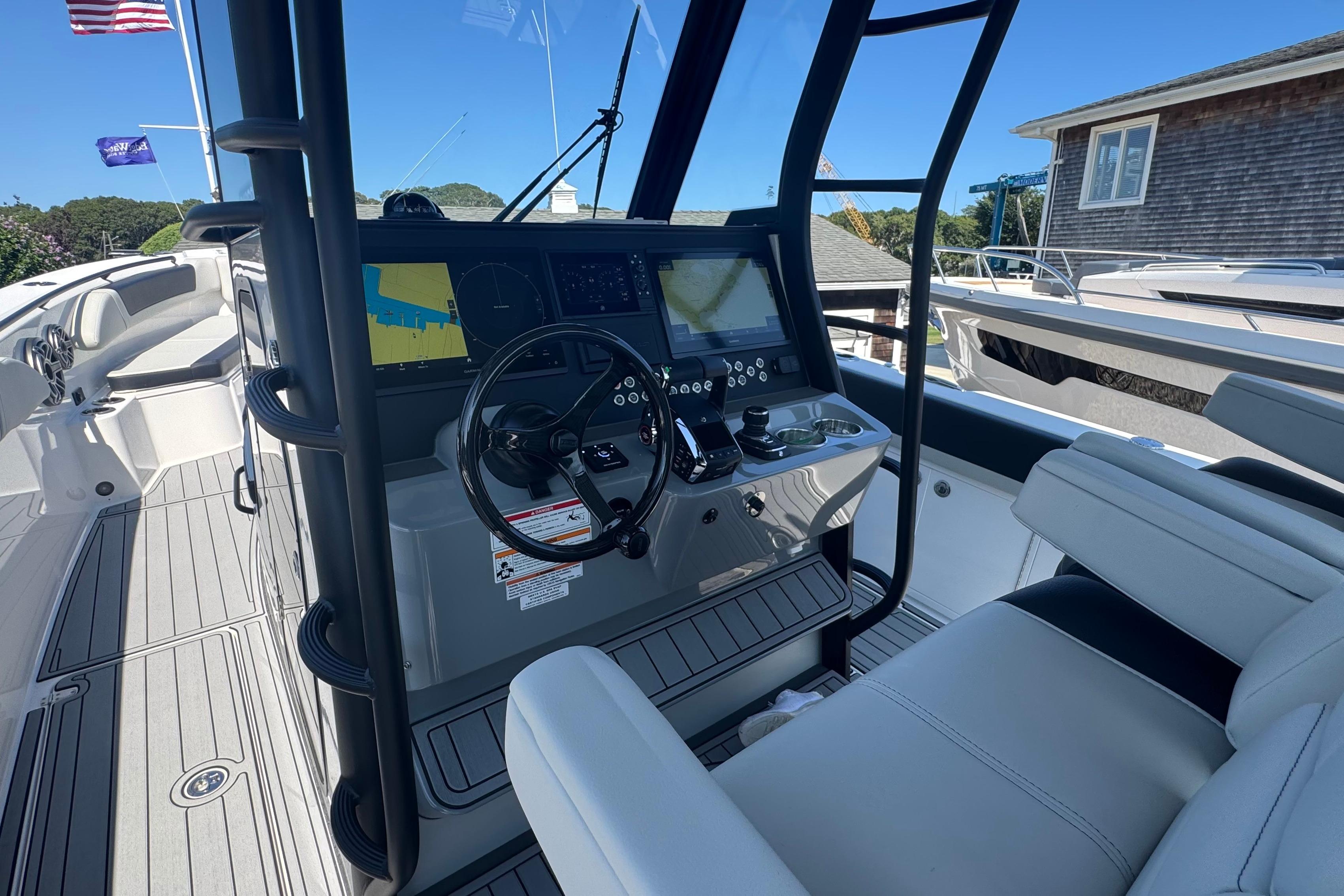 2025 Edgewater 340CC boat cockpit with modern navigation system and comfortable seating.