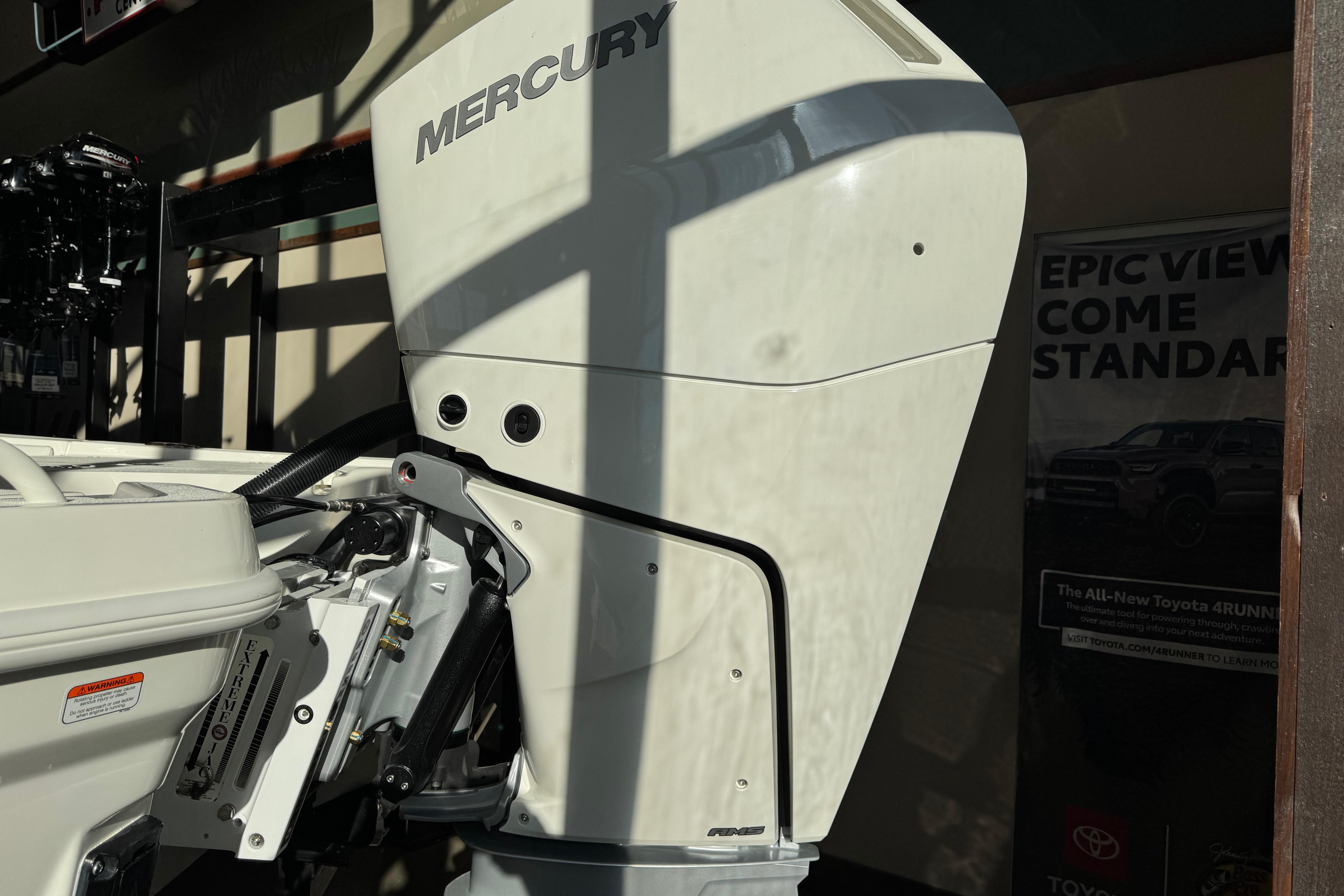 Outboard motor on a 2026 Mako 24 APEX boat, featuring Mercury branding.