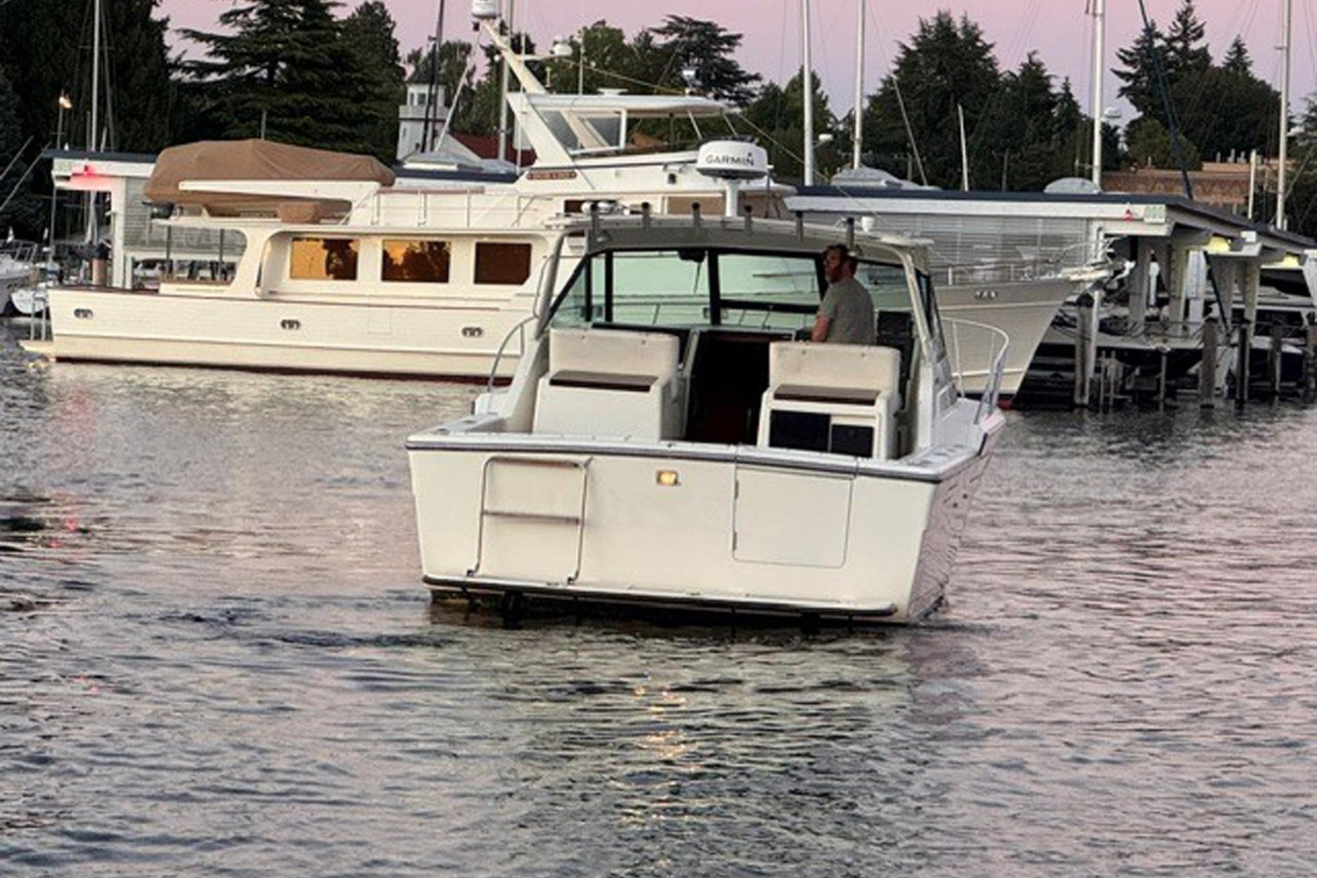 1988 Tiara Yachts 3300 Open boat docked in a marina at sunset.