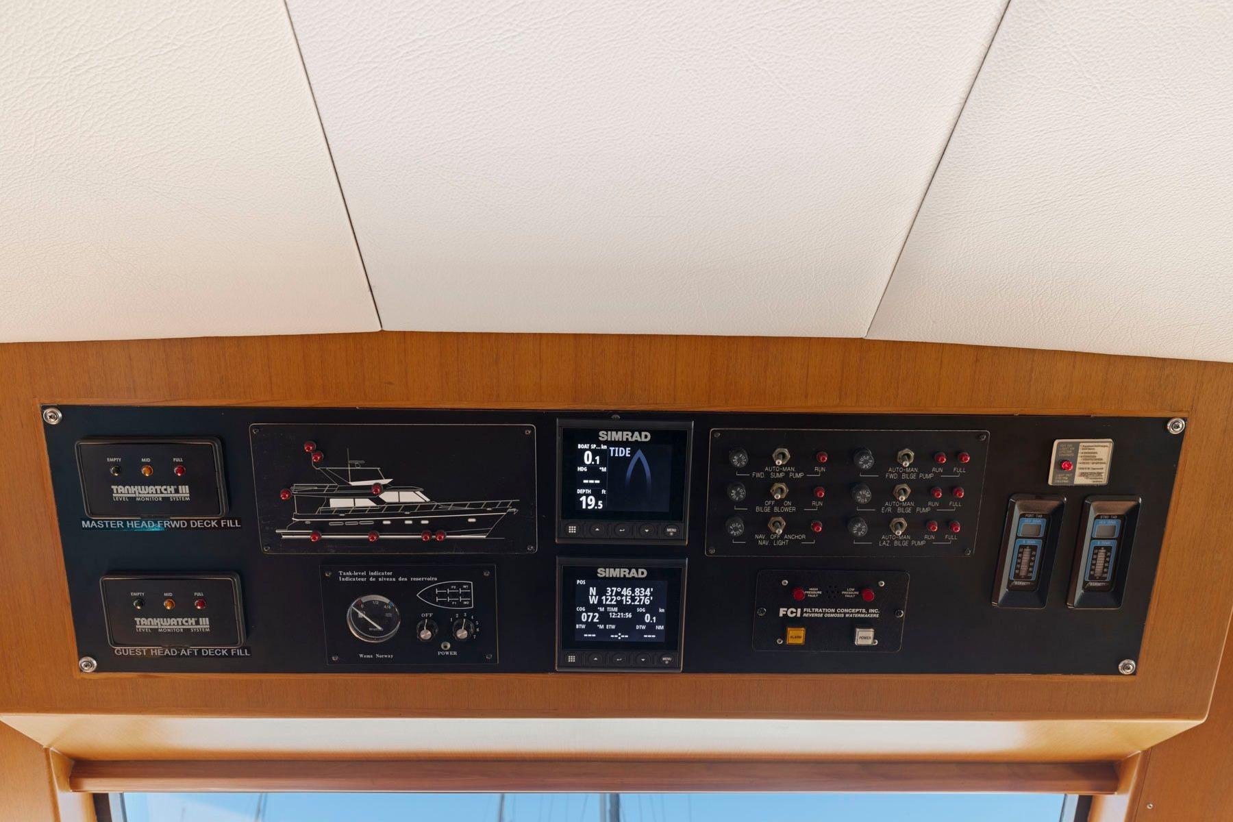 Control panel of a 1999 Symbol 55 yacht with various gauges and displays.