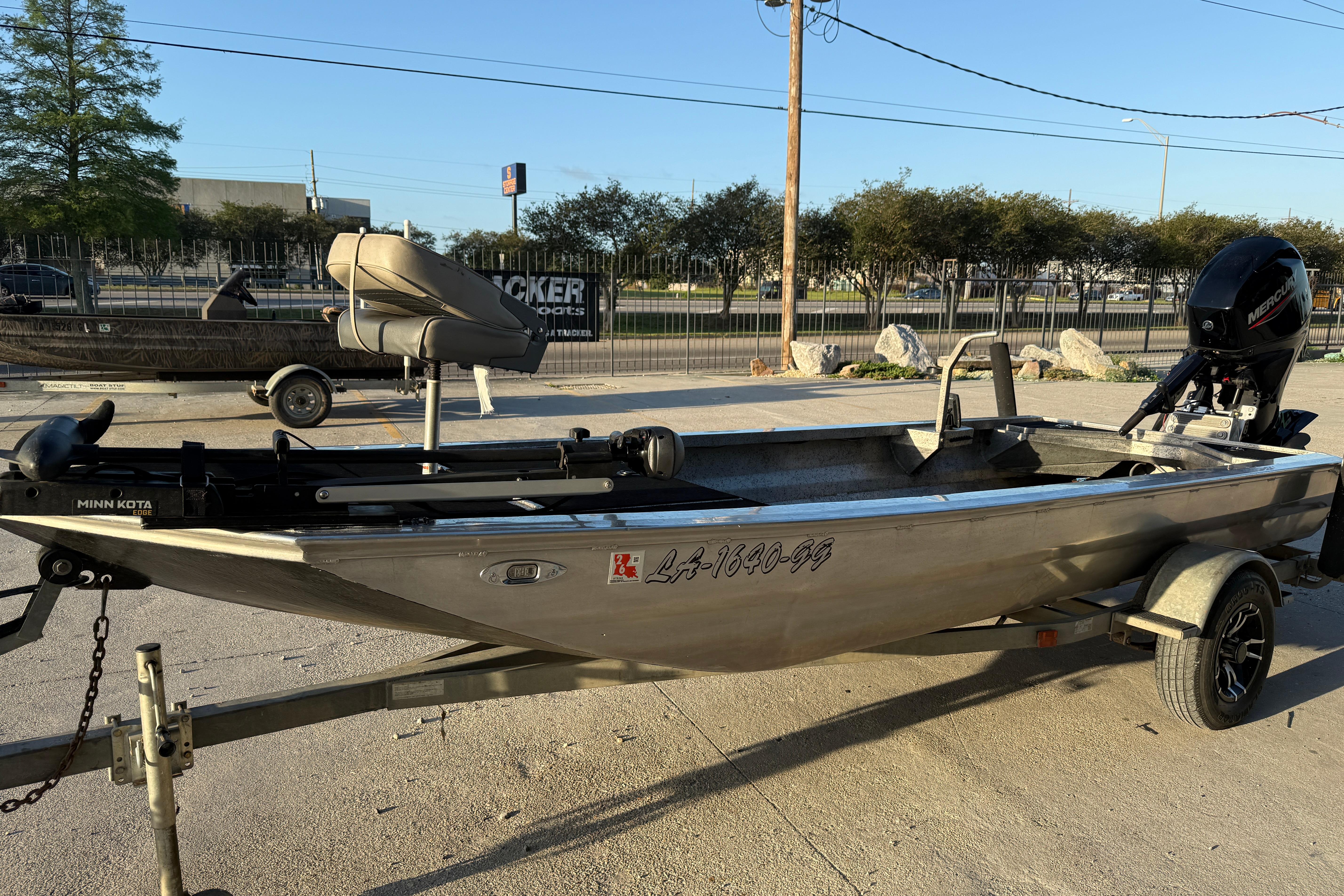 2017 Homemade 1754 boat on trailer with Minn Kota motor, parked outdoors.