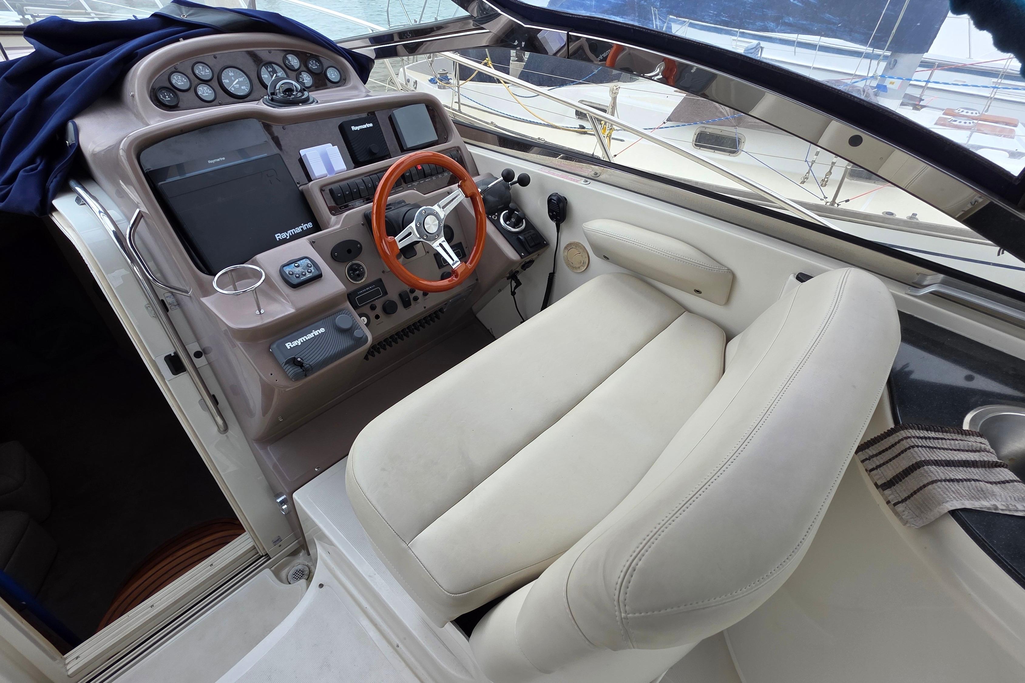 Cockpit of 2002 Regal Commodore 4260 yacht with steering wheel and navigation controls.