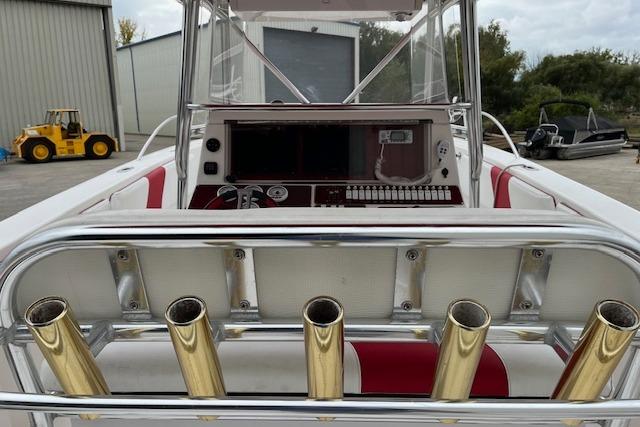 2001 Fountain 38 Center Console boat with rod holders and control panel.