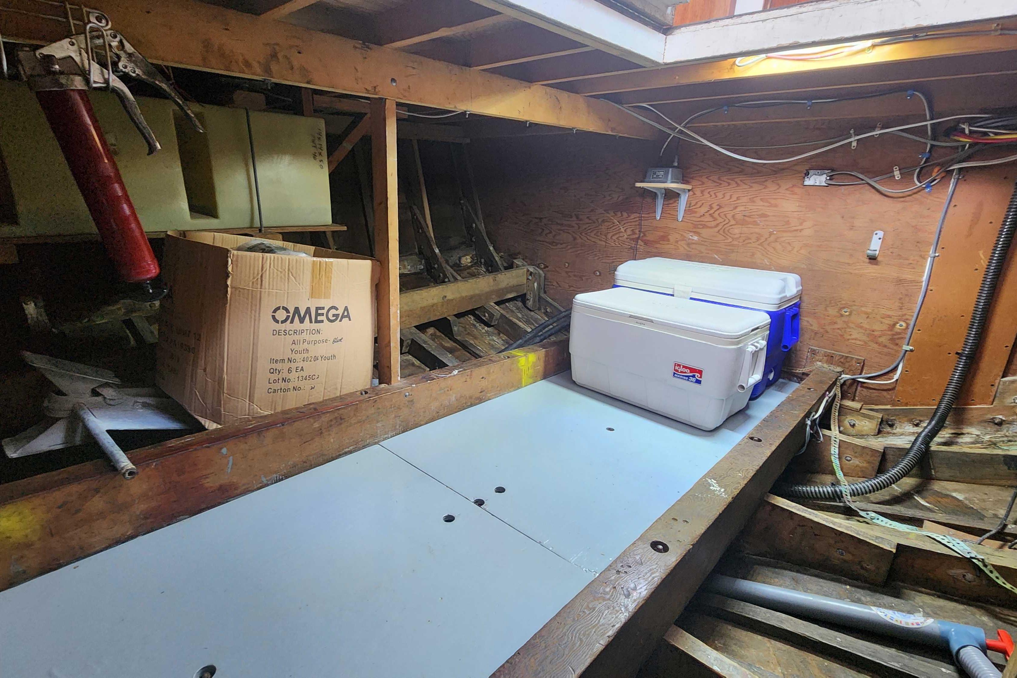 Interior of a 1964 Grandy Tour Boat with coolers and storage box.