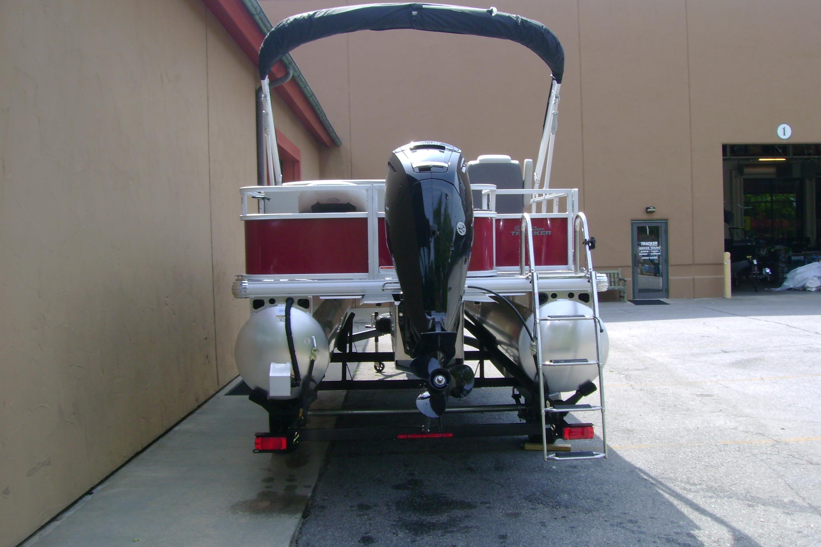 2026 Sun Tracker Bass Buggy 18 DLX pontoon boat, rear view with motor and ladder.