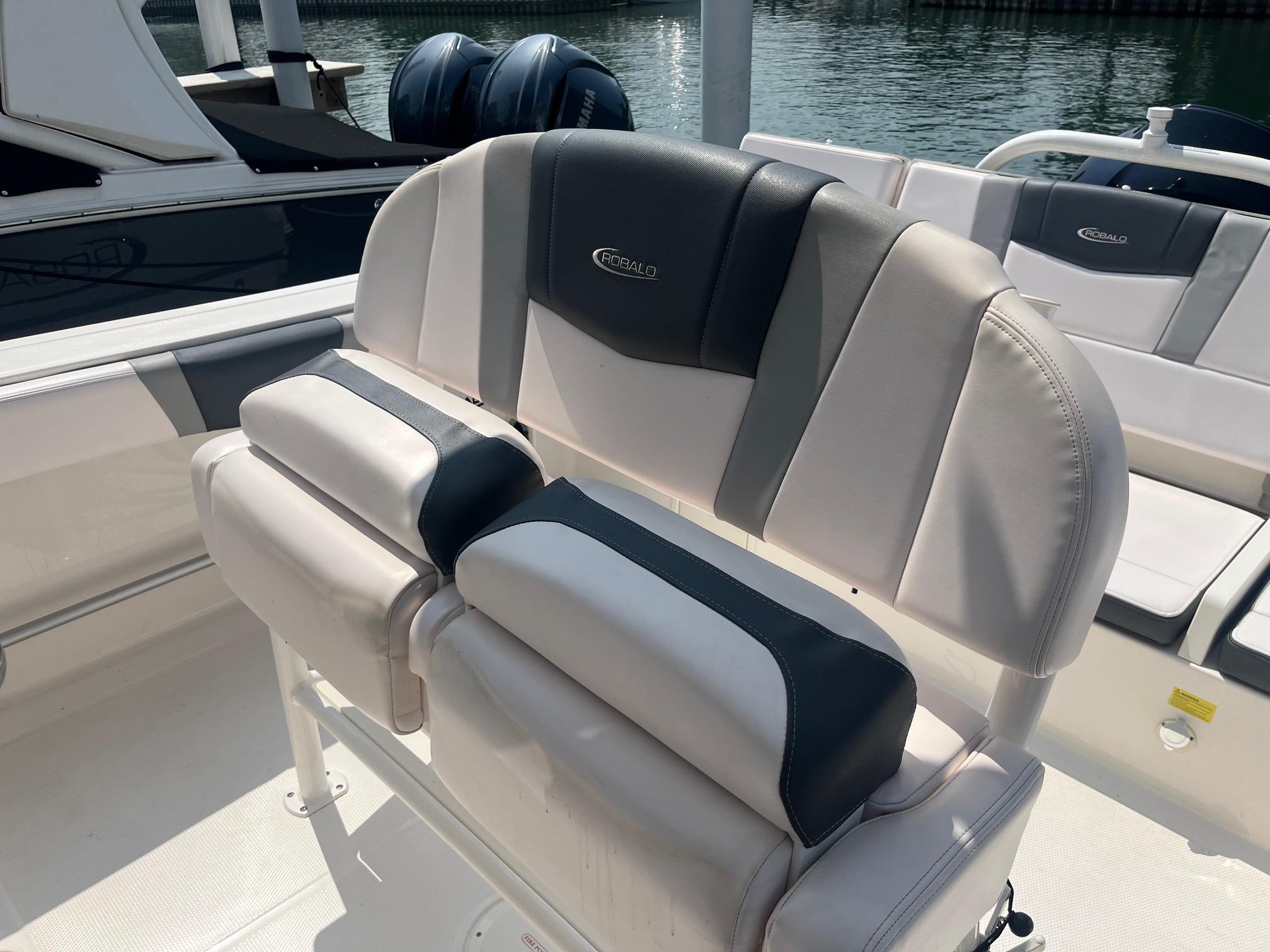 2020 Robalo R230 Center Console boat seating with dual engines in background.