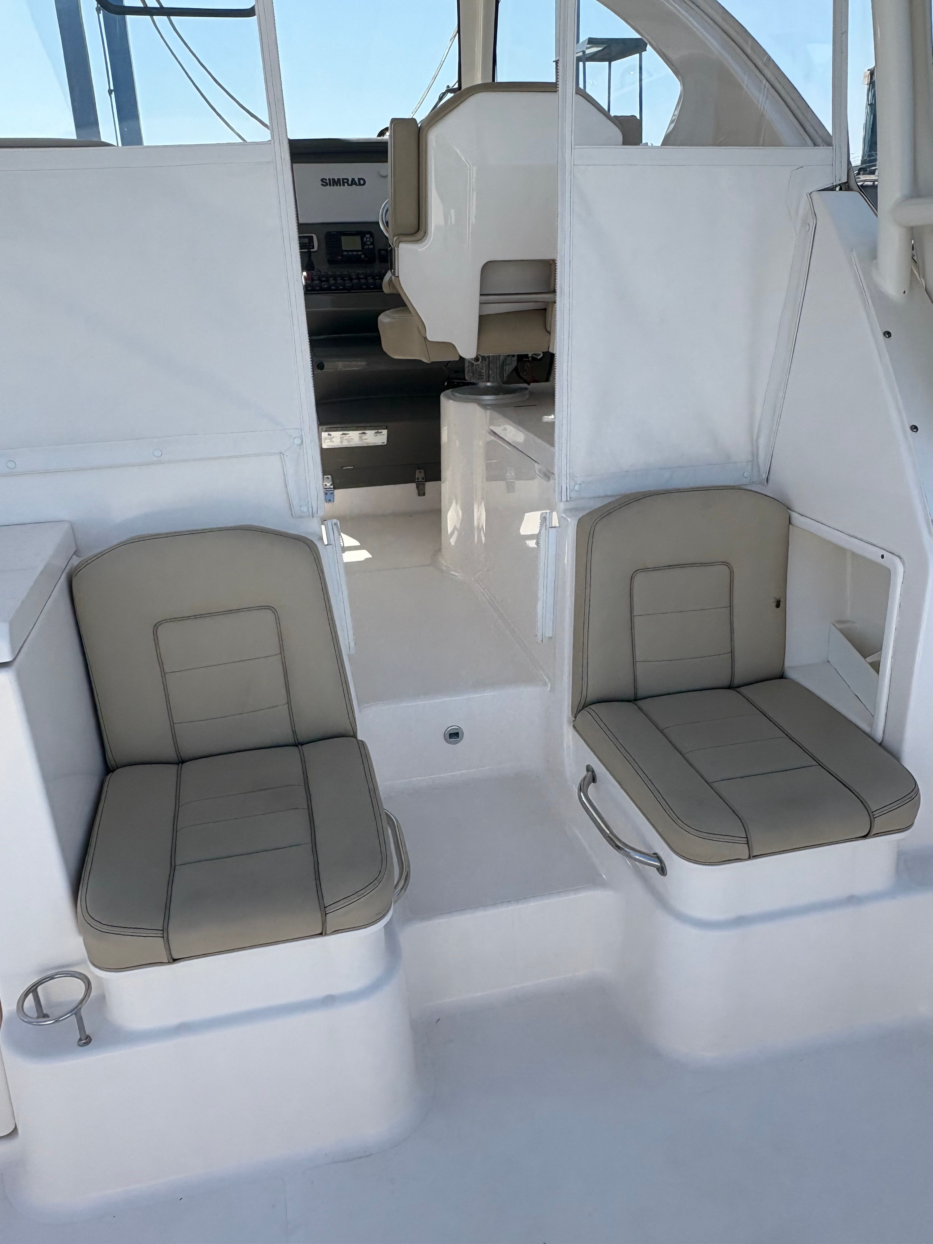 2017 Pursuit OS 355 Offshore boat interior with beige seating and helm station.