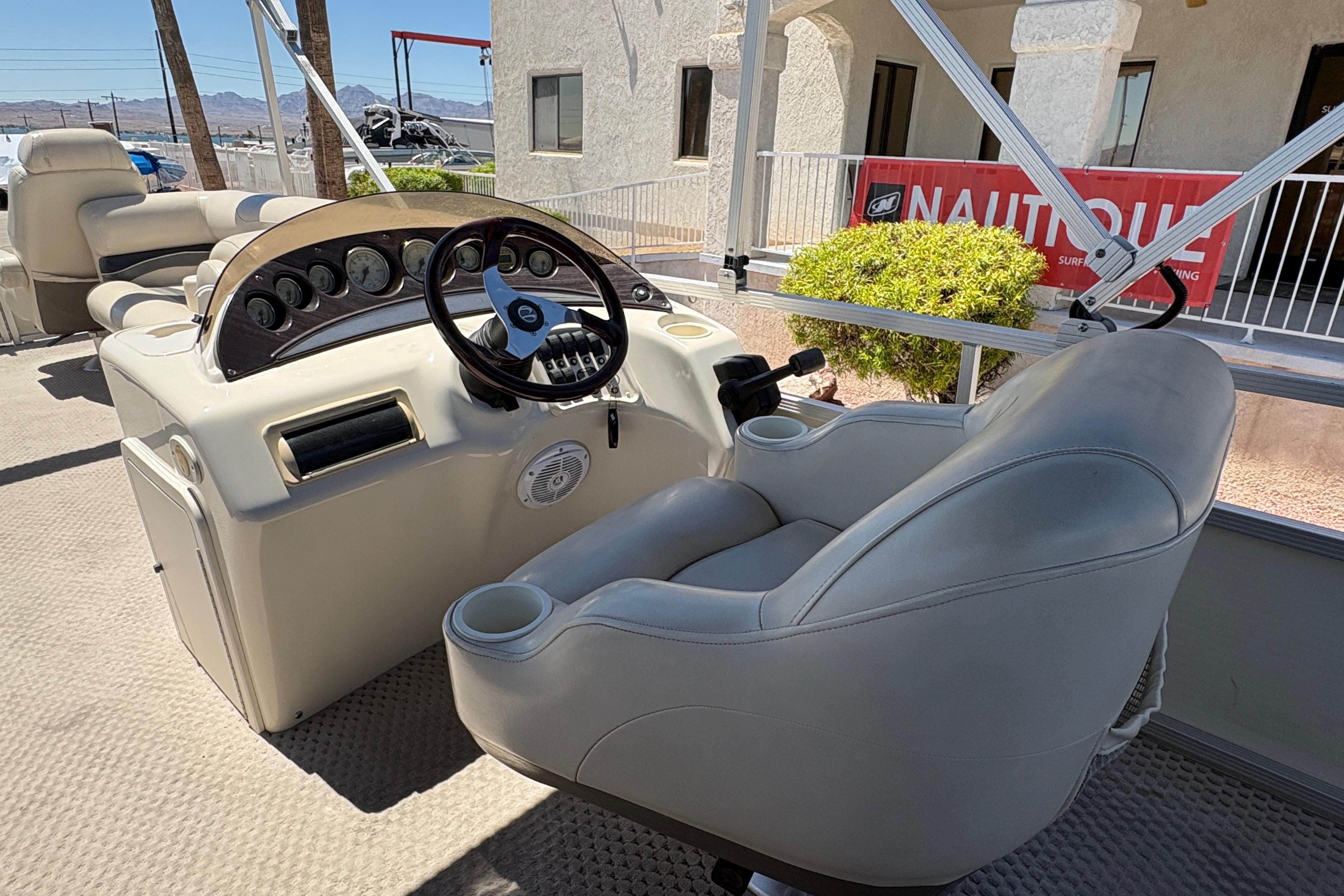 2005 Bennington 2575RFS I/O boat interior with steering console and seating.